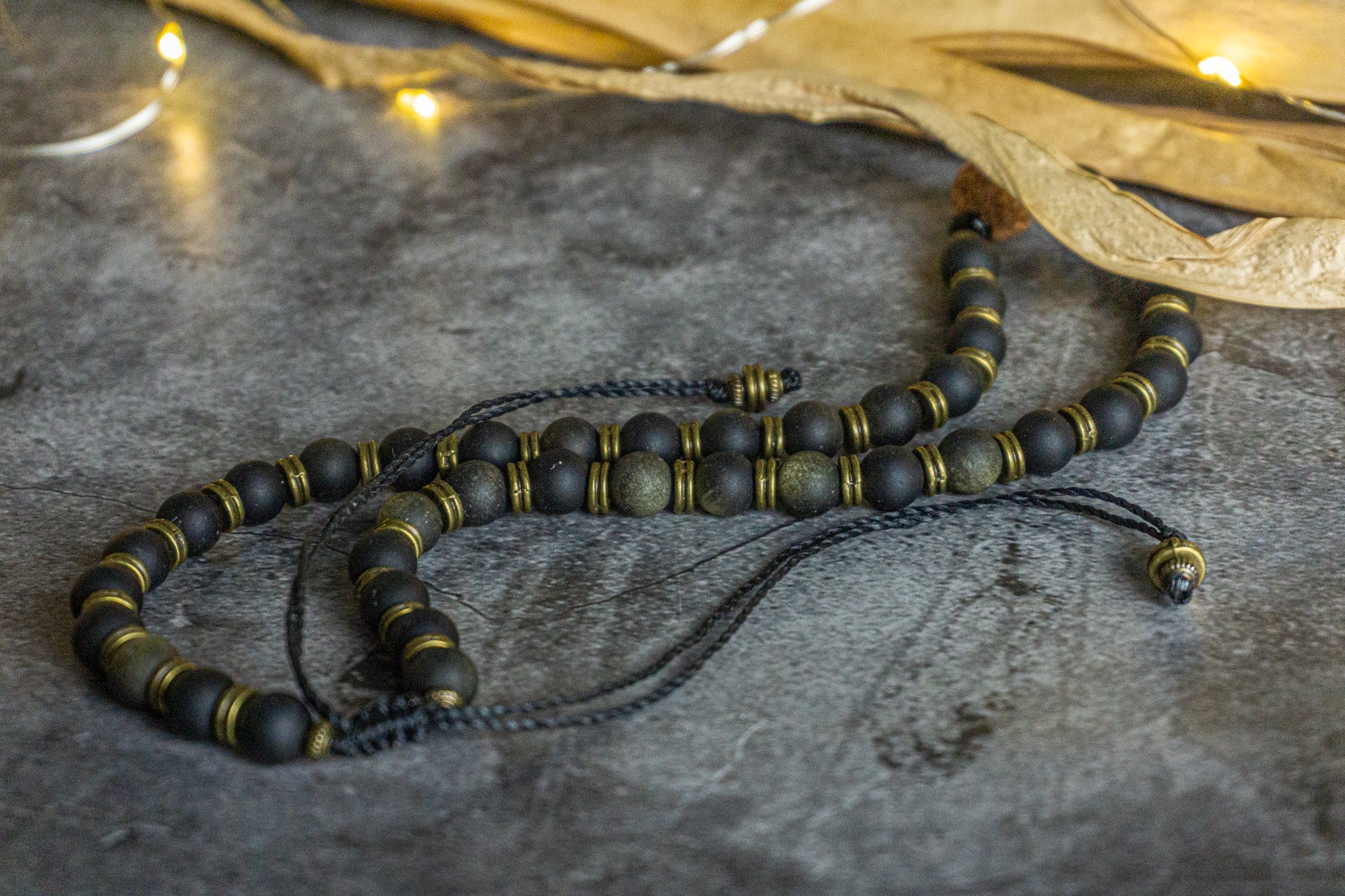 golden obsidian beaded necklace with brass spacers and rudraksha seed as central piece- wander jewellery