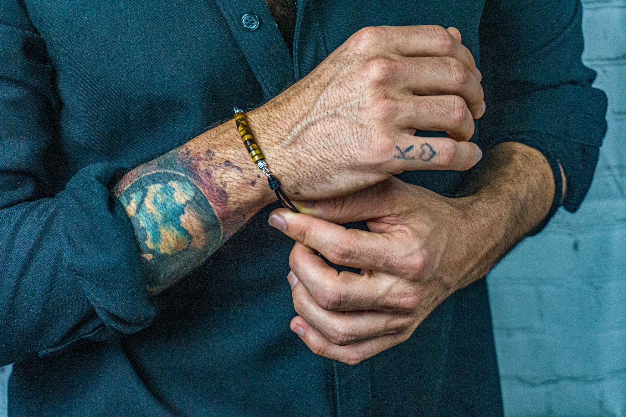 mens black leather bracelet with tiger eye heishi gemstone beads and silver details- wander jewellery