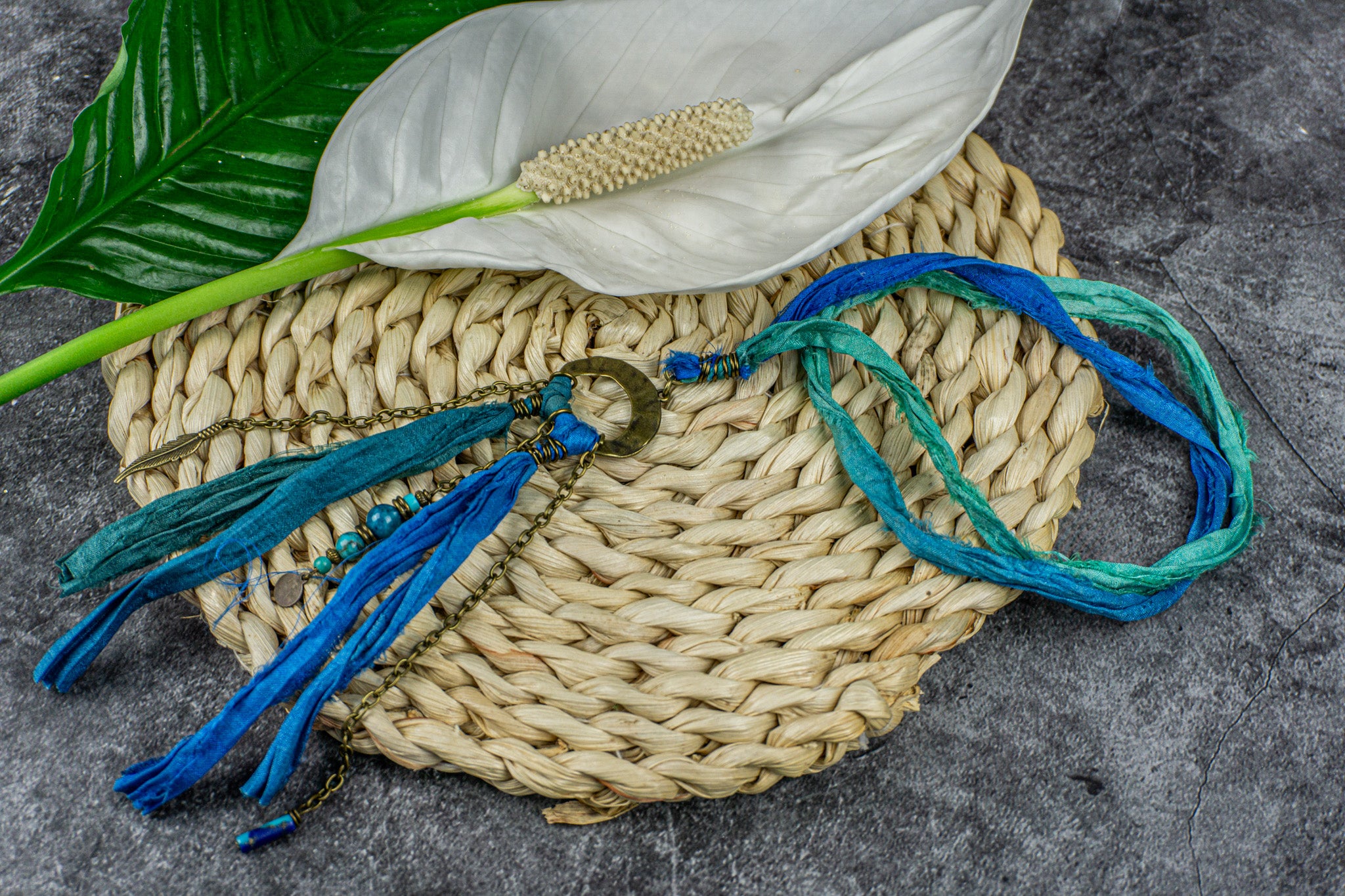 Long boho necklace with blue silk, brass, and gemstone charms, perfect for a bohemian style – Wander Jewellery