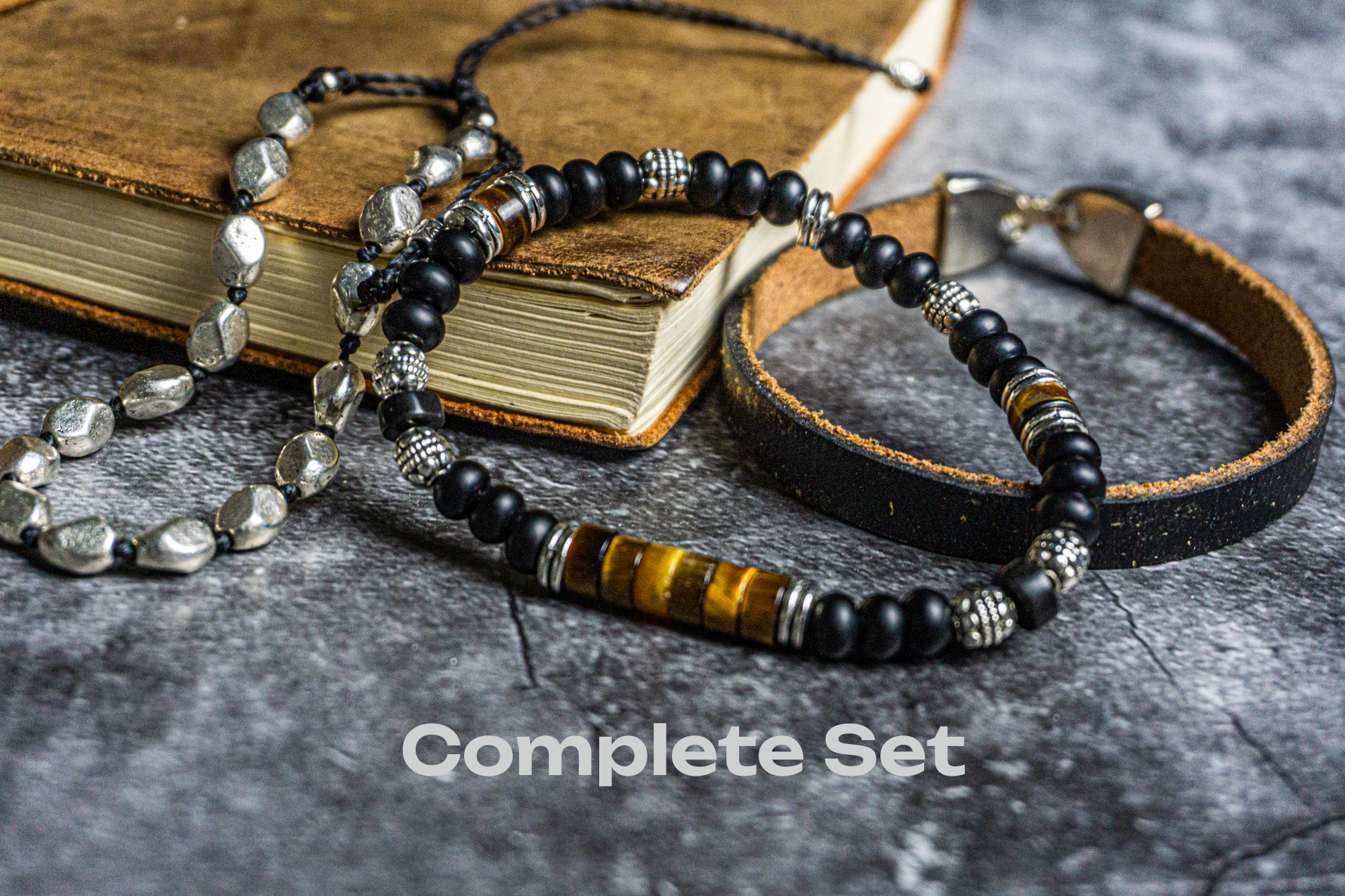 dream bracelet set made of one onyx and tiger eye bracelet, one black leather vintage bracelet and one silver colored adjustable bracelet- wander jewellery