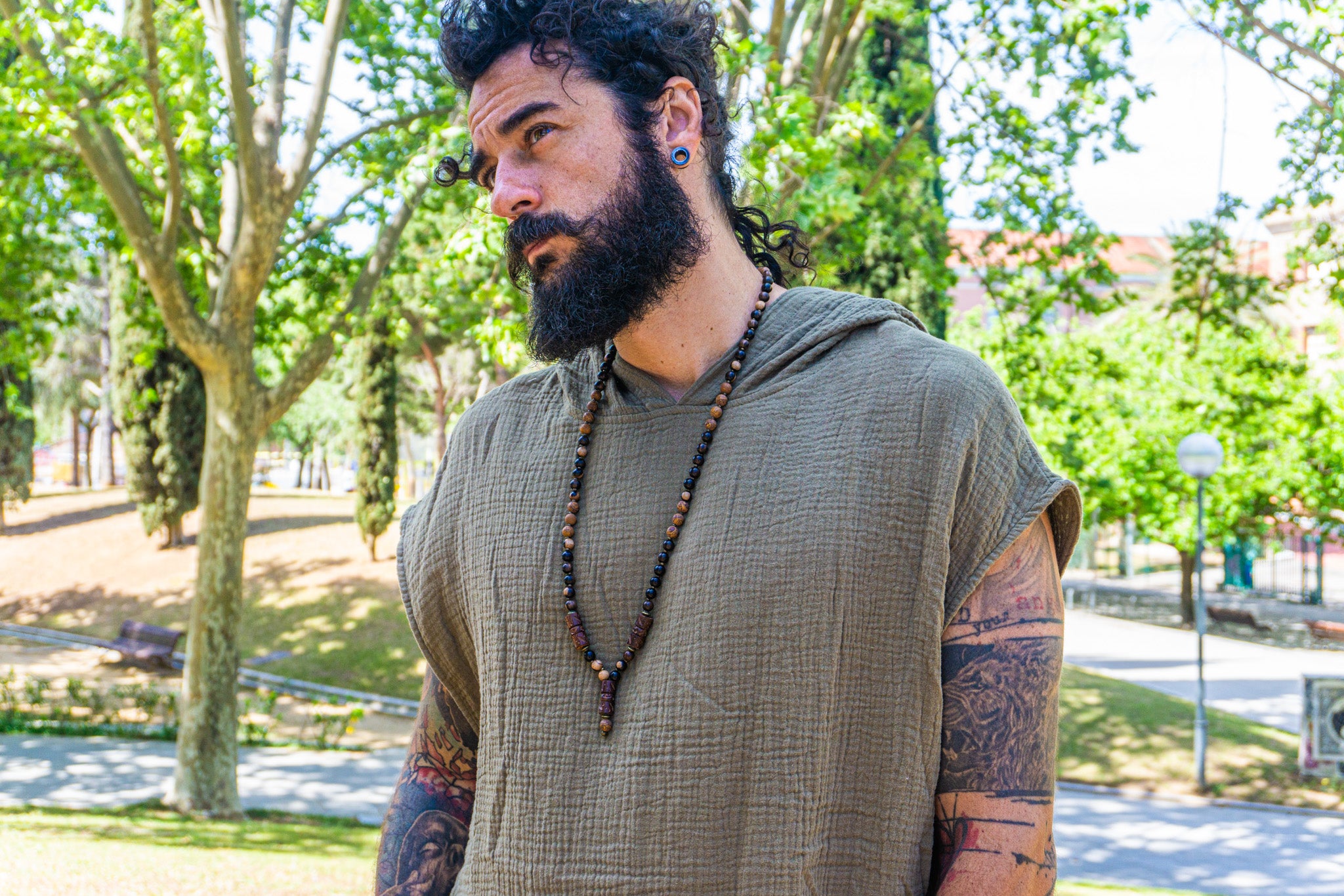 mens ebony wood and elephant skin beaded necklace with bronze details and three carved ebony wood pieces