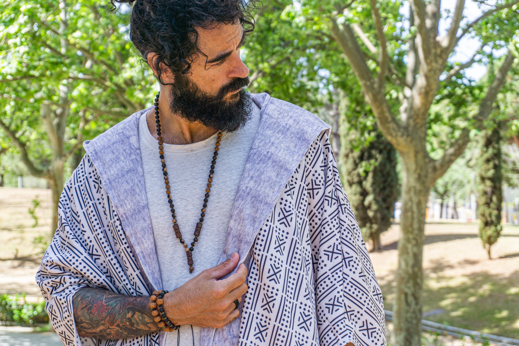 mens dark ebony wood and elephant skin beaded necklace with bronze details and three carved ebony wood pieces