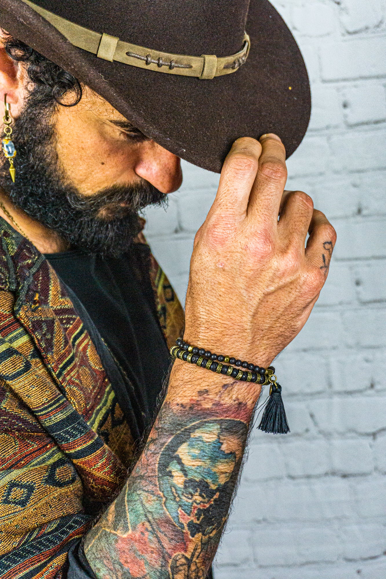 mens black lava stone bracelet set made of one bigger brass and lava stone bracelet and one with small lava beads and a tassel dangle- wander jewellery