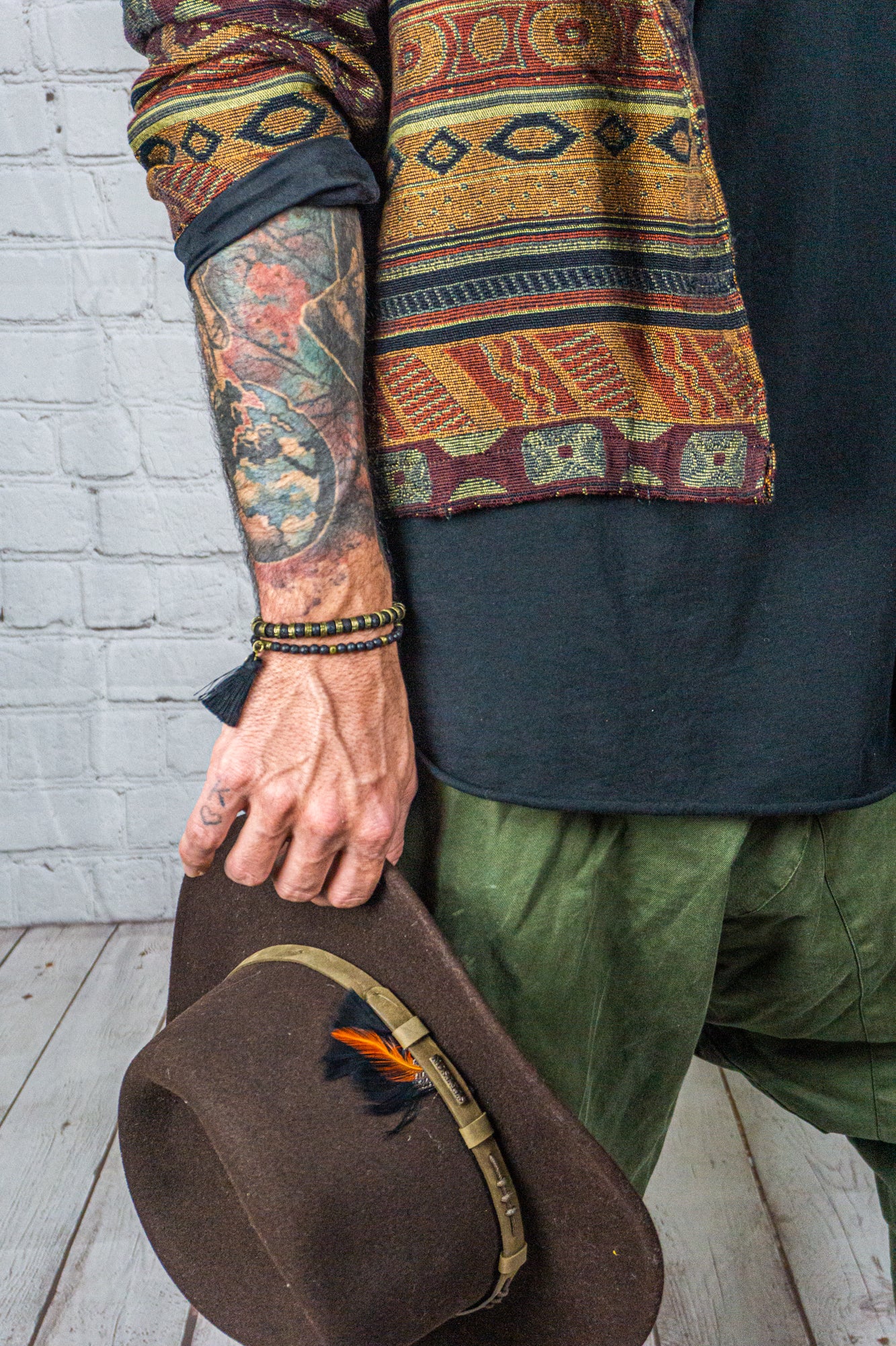 mens lava stone bracelet set made of one bigger brass and lava stone bracelet and one with small lava beads and a tassel - wander jewellery