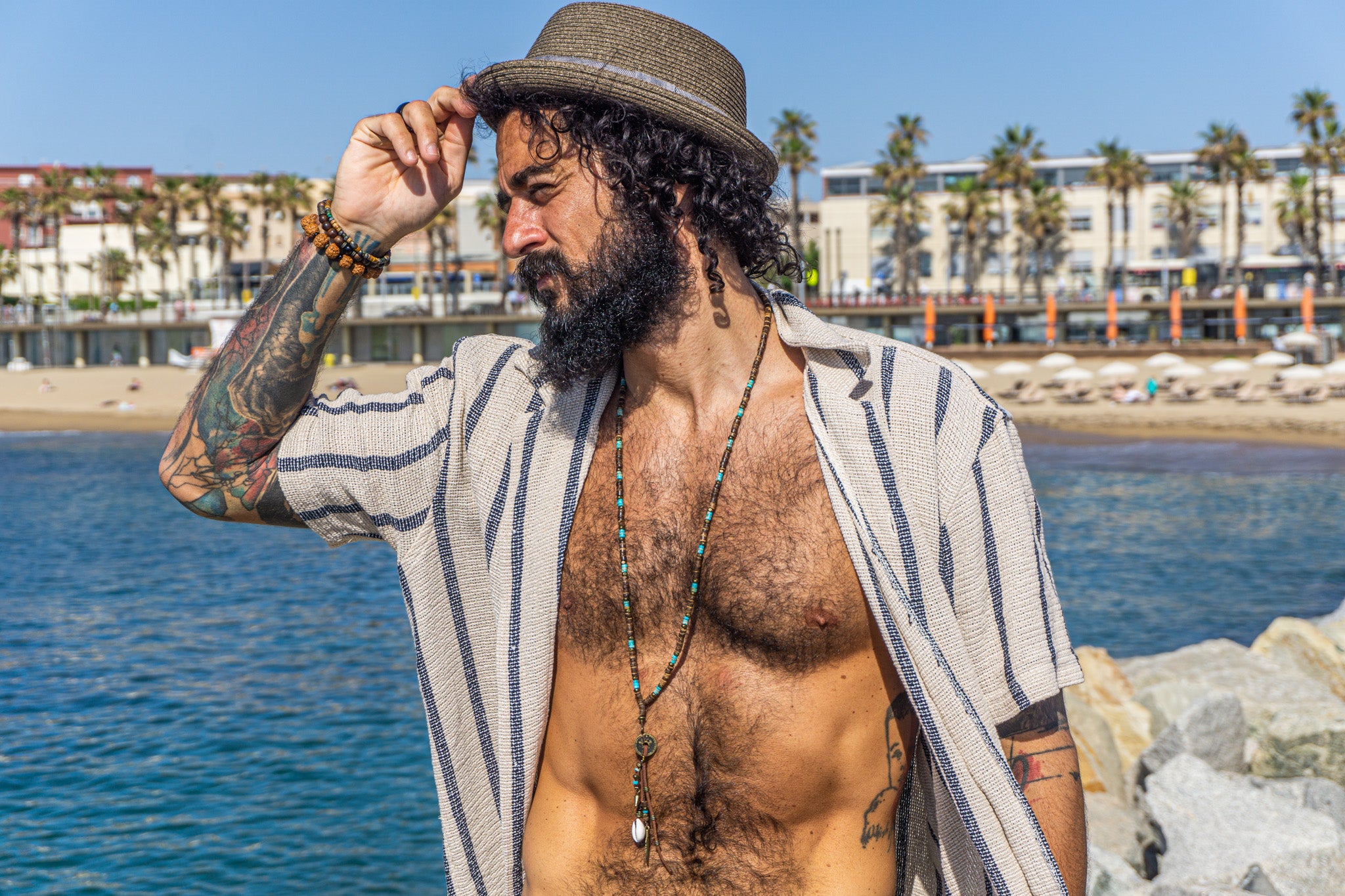 mens extra long coconut shell and turquoise gemstone bead, with a long tribal multi charm pendant- wander jewellery