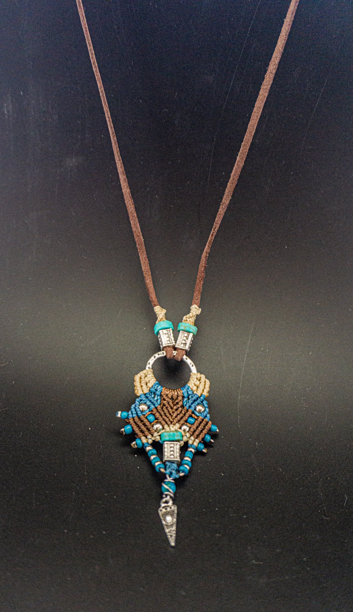 Necklace with a decorative pendant on a black background