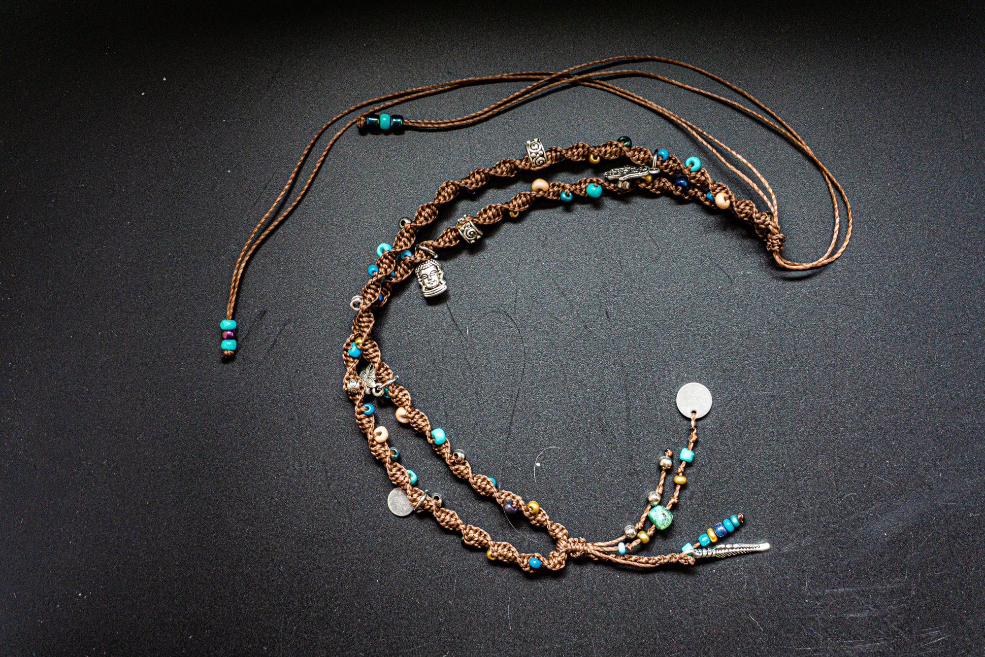 Beaded necklace with decorative elements on a dark background