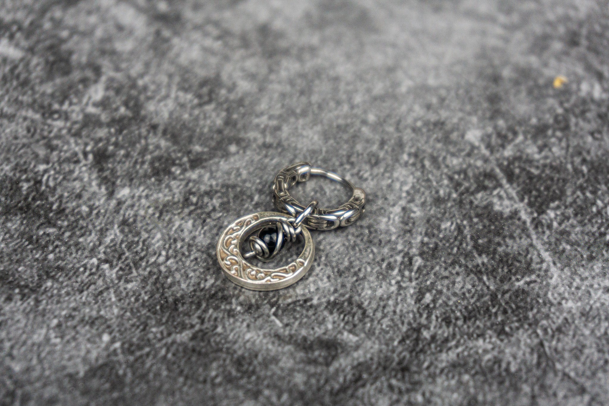 stainless steel hoop earring with an abstract moon charm with a dangle onyx bead- wander jewellery