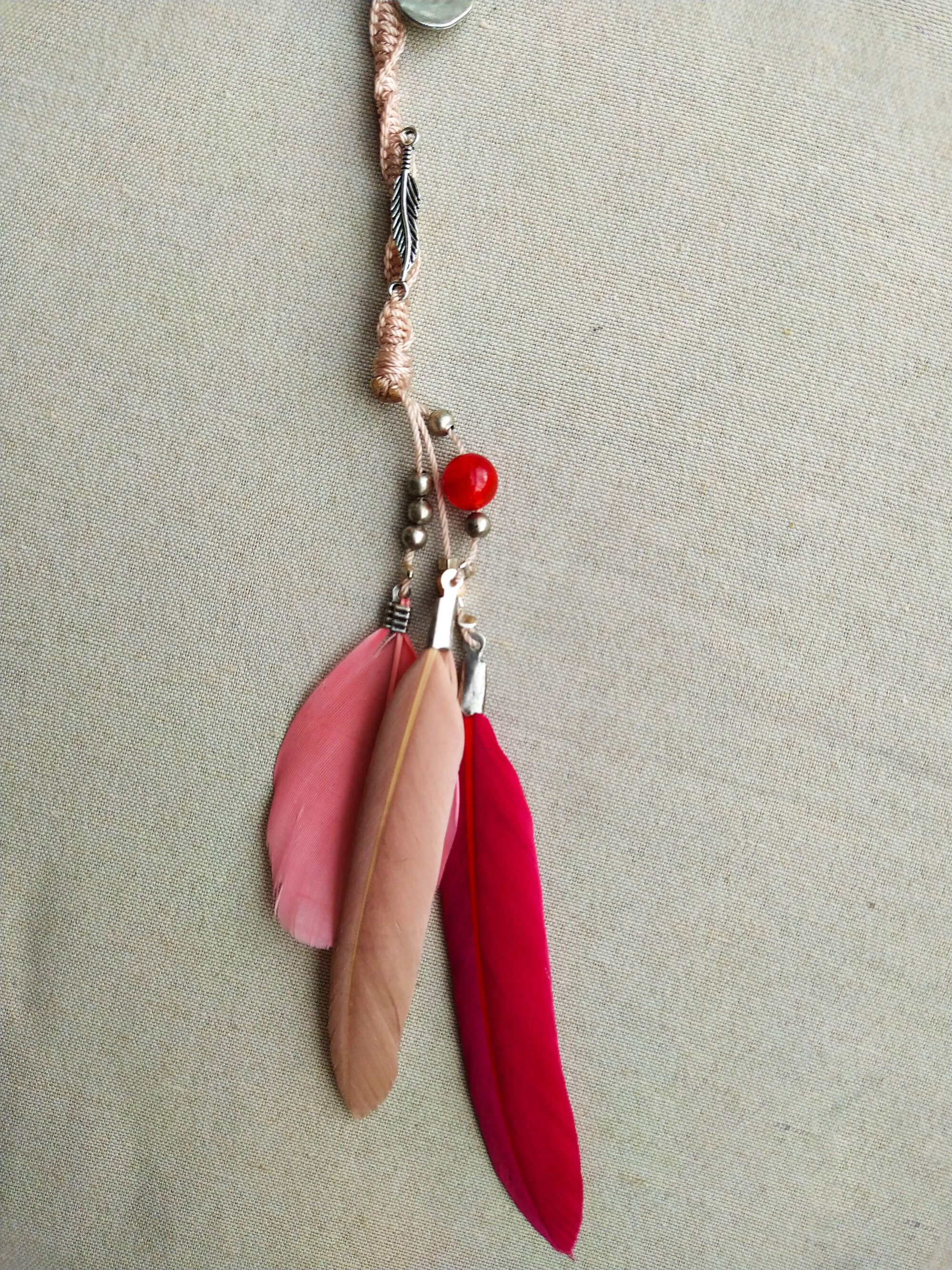 pink feathers dangle from a pink hair wrap- ewander jewellery- wander jewellery