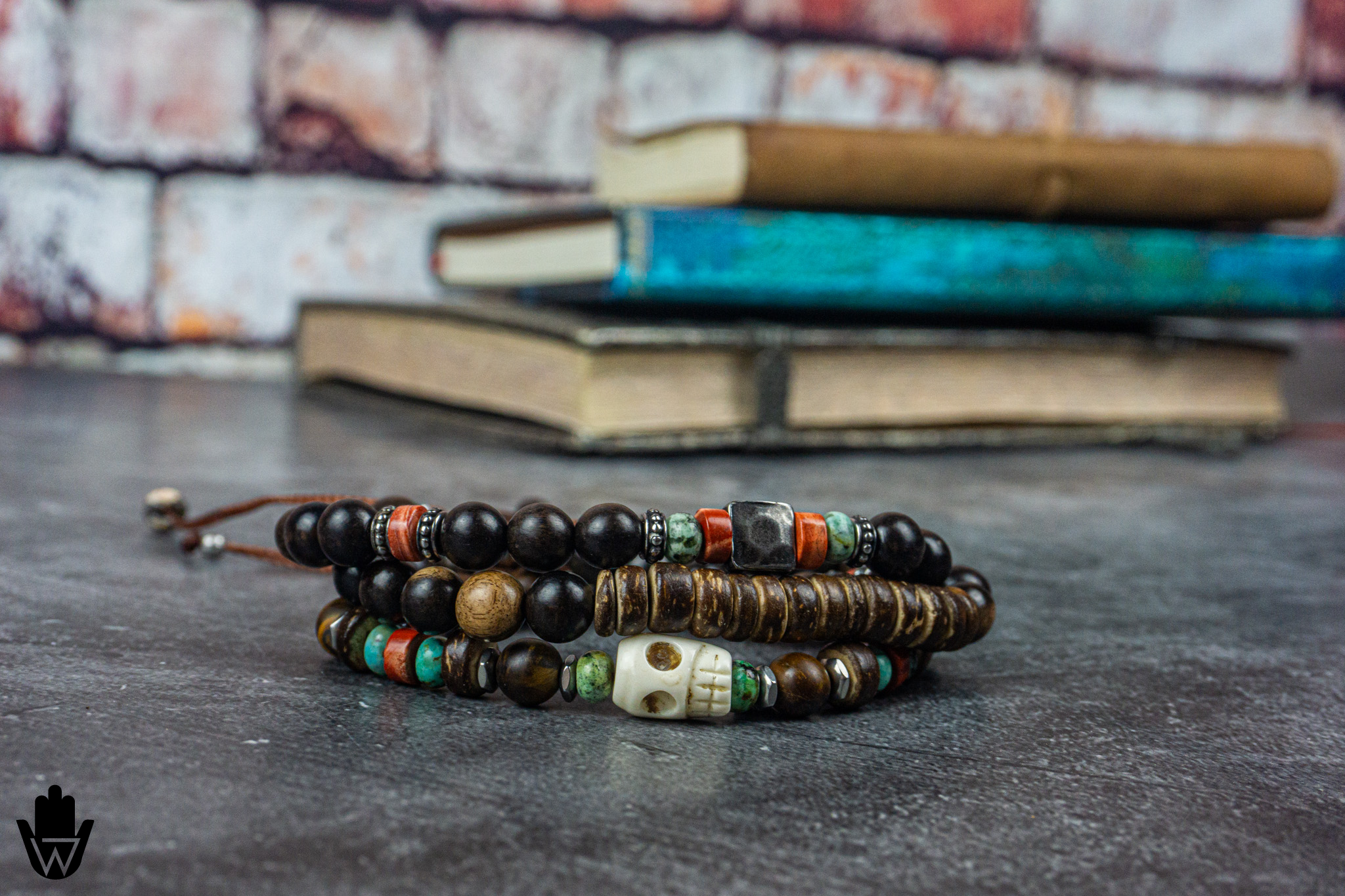 beaded bracelet set made of ebony wood, coconut, gemstones, with a skull charm as central piece- wander jewellery