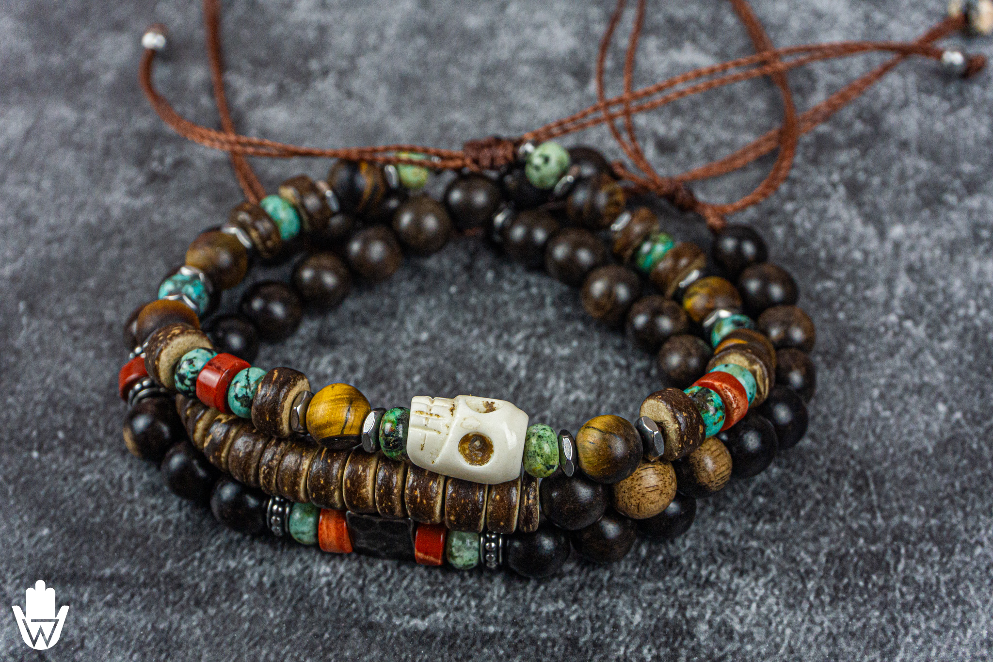 beaded bracelet set of 3 made of ebony wood, coconut, gemstones, with a skull charm as central piece- wander jewellery
