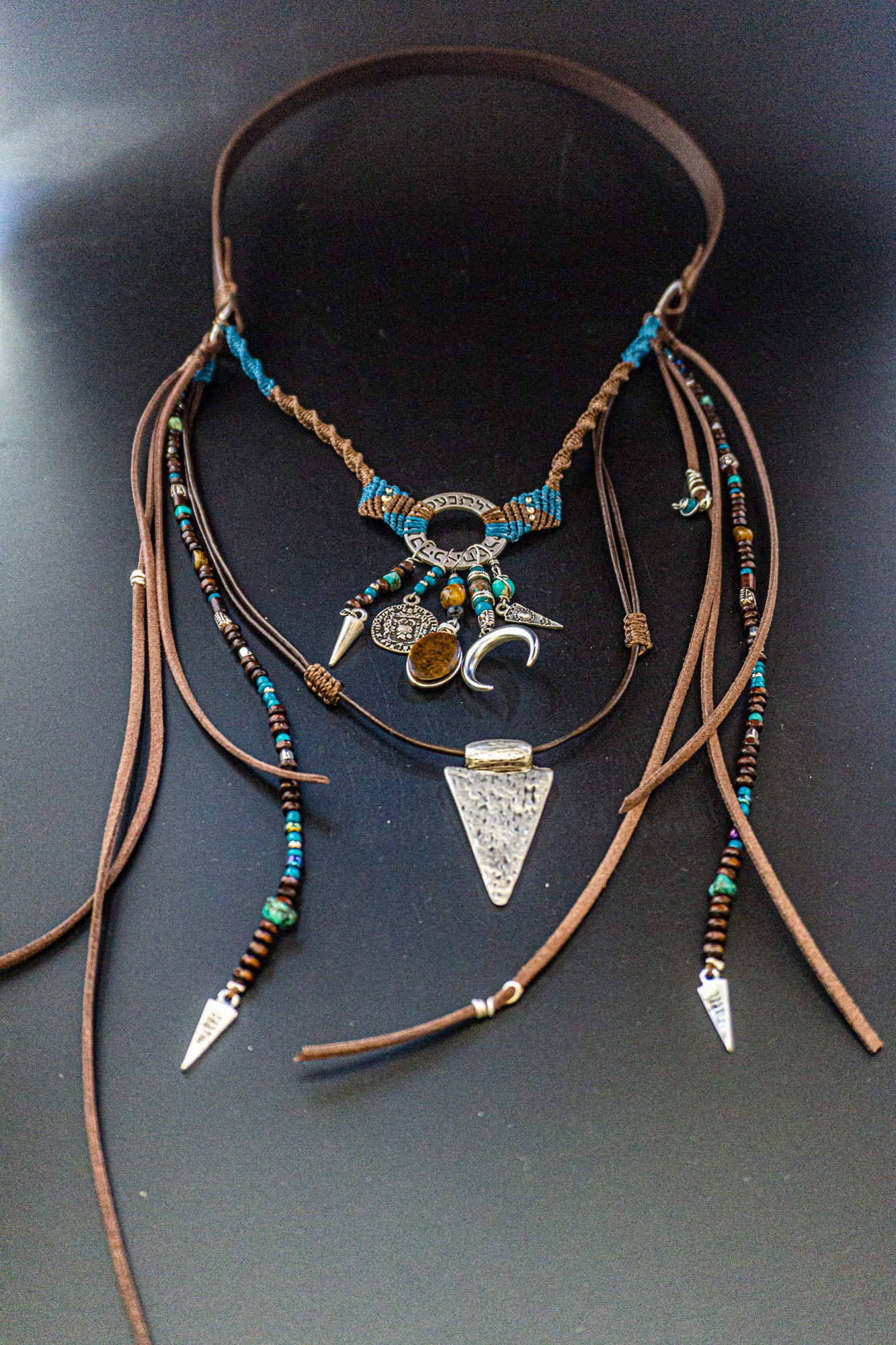 boho statement necklace made of macrame aand leather, with different layers charms and dangling beaded strings and fringes- wander jewellery