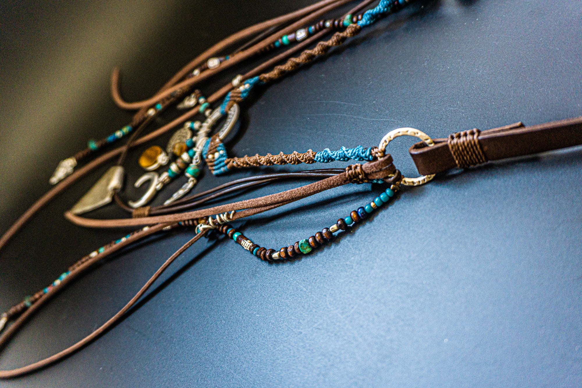 necklace made of macrame aand leather, with different layers charms and dangling beaded strings and fringes- wander jewellery