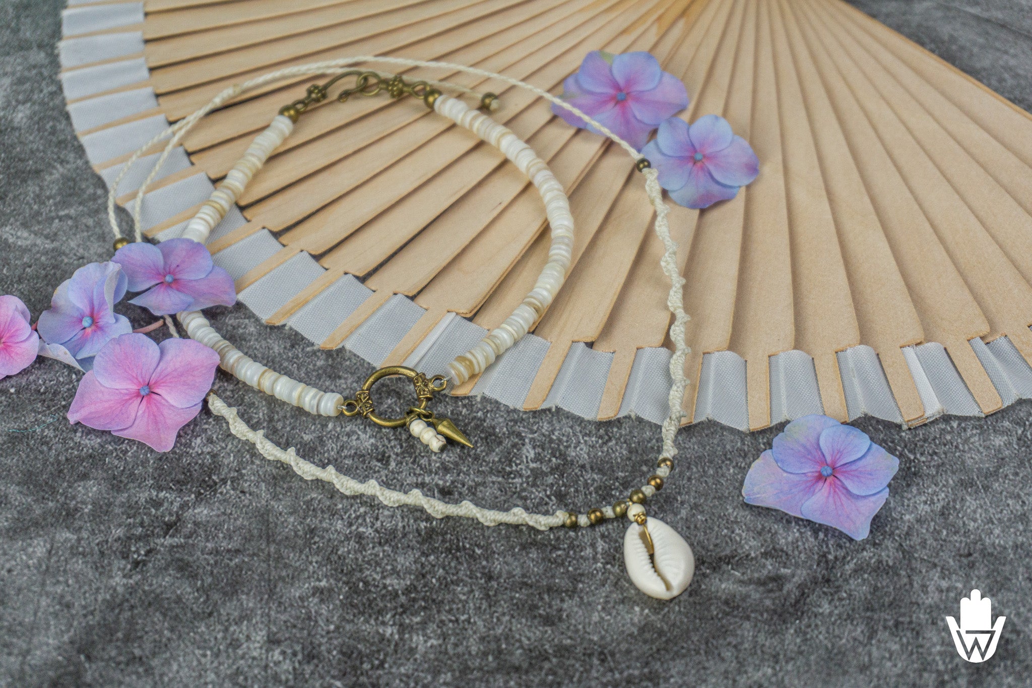seashell necklace set with bronze deatils on a decorative surface
