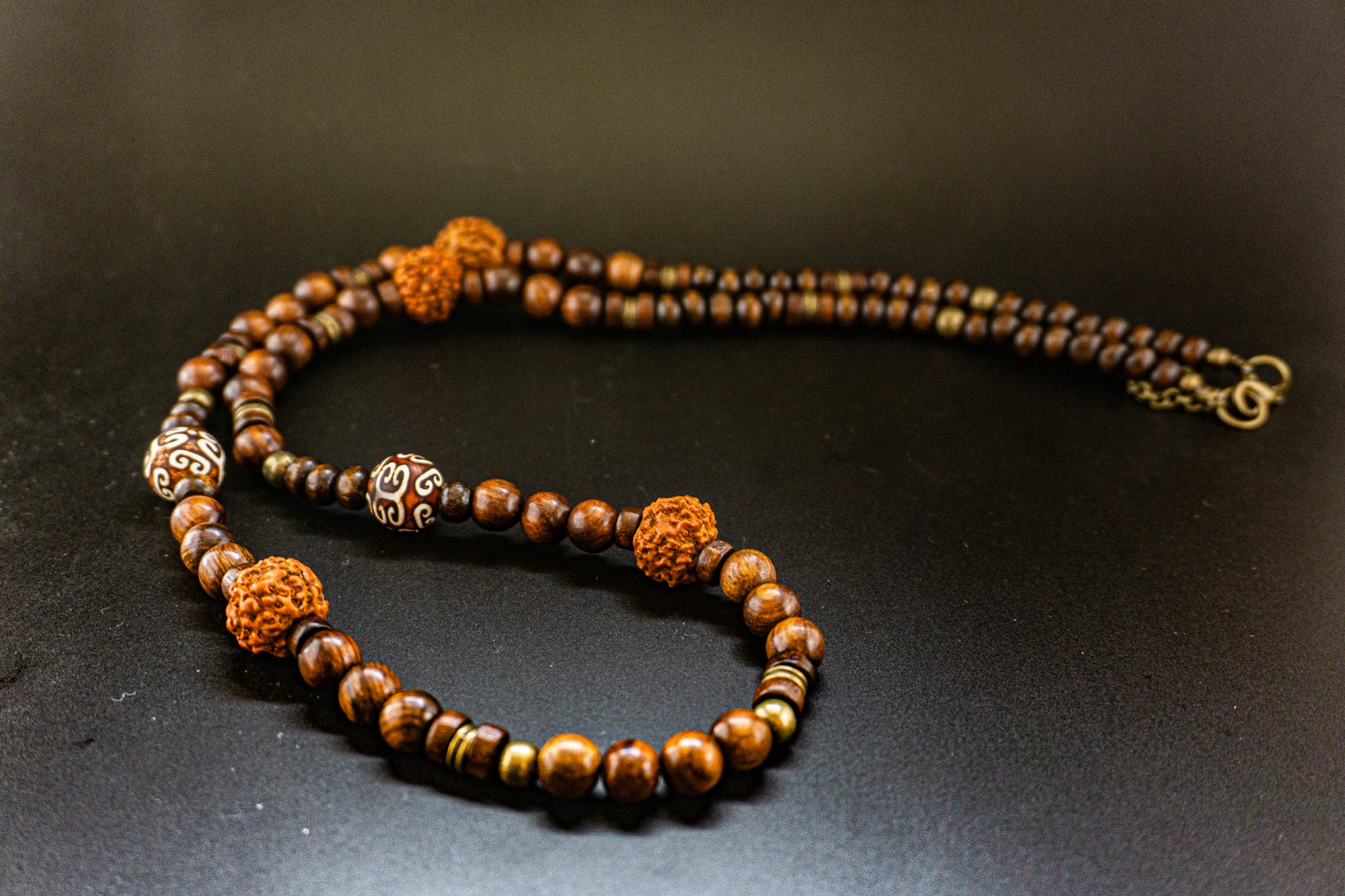 long wooden beaded necklace with rudraksha seeds and bronze details- wander jewellery