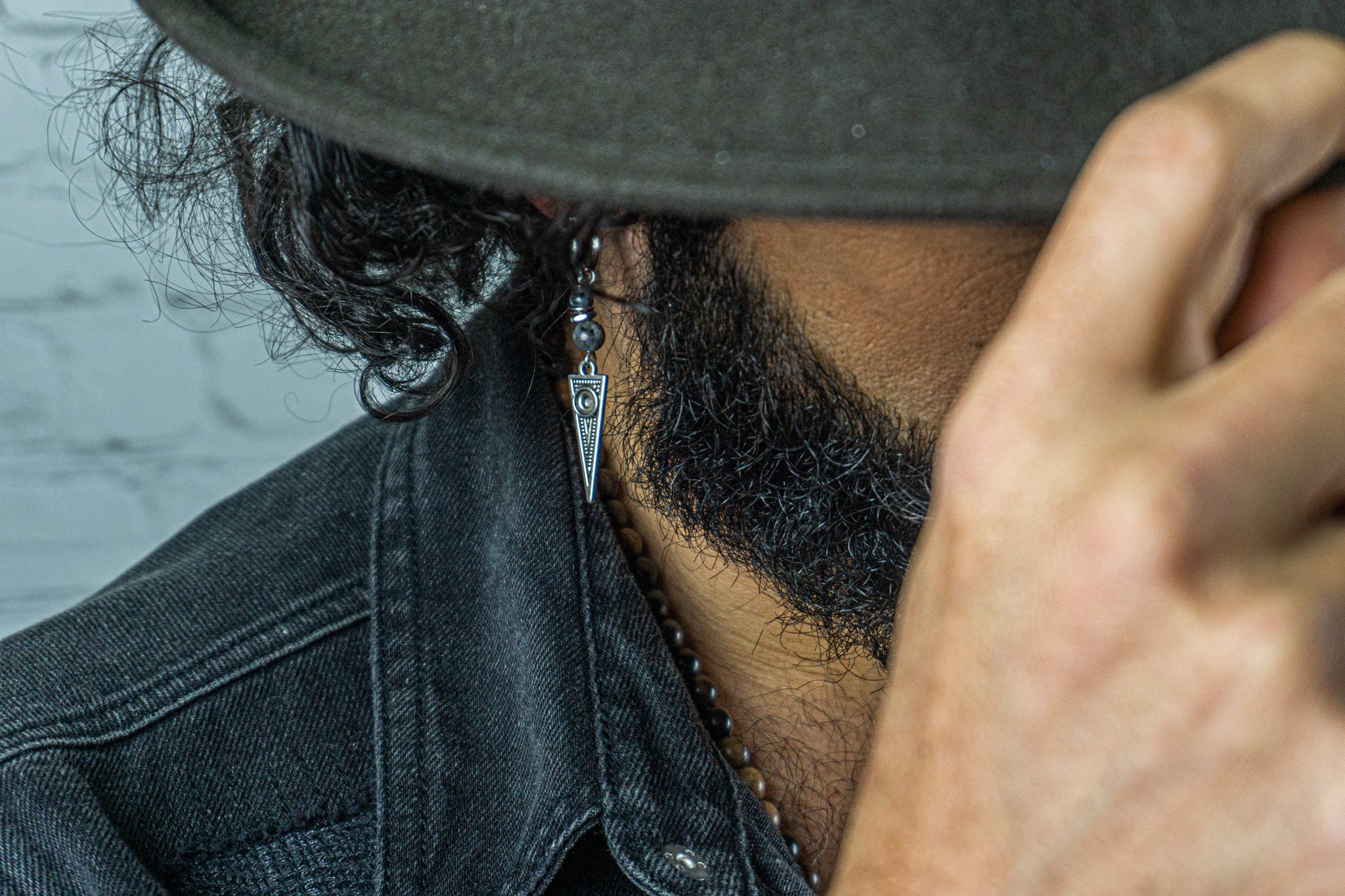 mens wearing a stainless steel hoop triangle earring with a grey gemstone