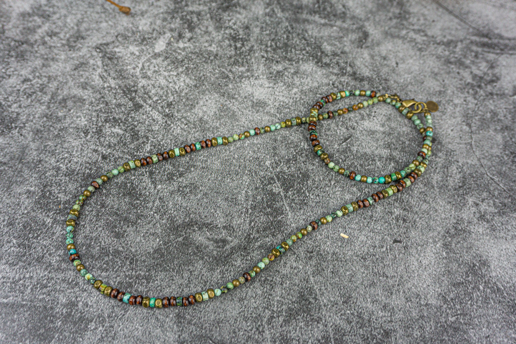 Long dainty green african turquoise, woodand brass beaded necklace
