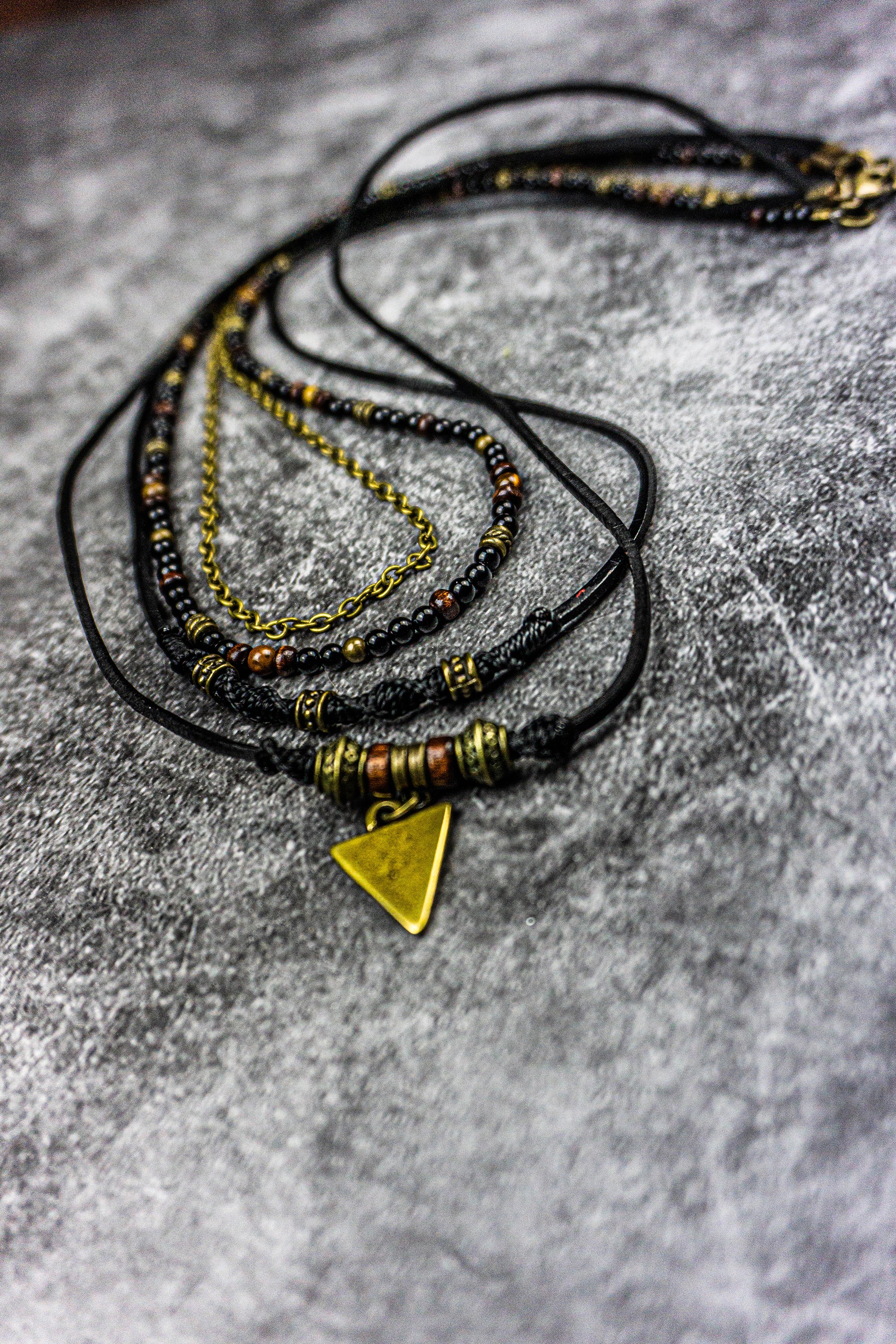 layered boho rockstar leather and gemstone necklace set with a central triangle charm