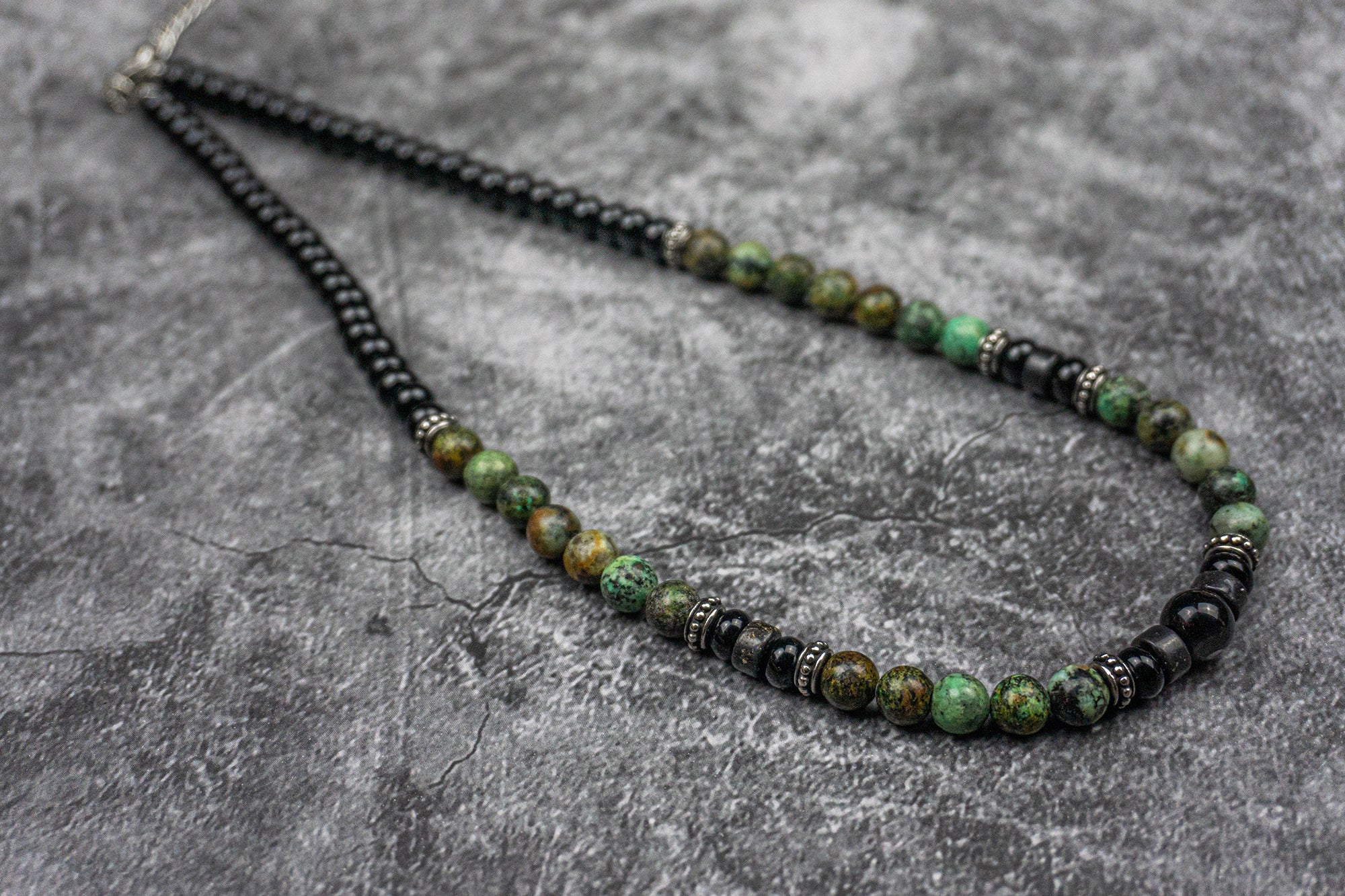 short necklace made of black onyx and green african turquoise gemstones, and stainless steel spacer beads