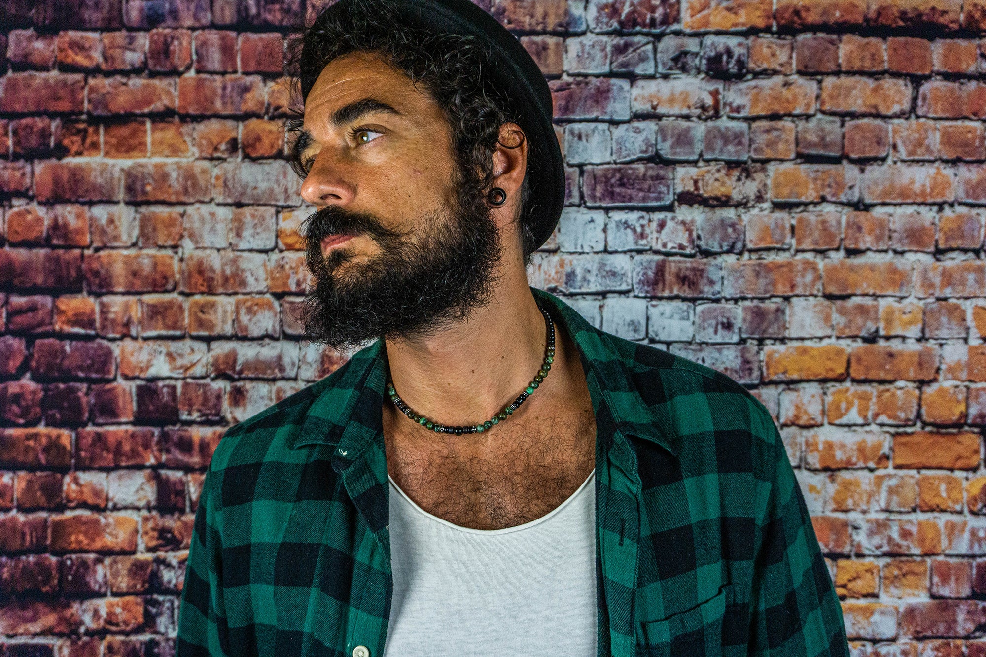 men waering a black and green gemstone beads choker necklace with stainless steel details
