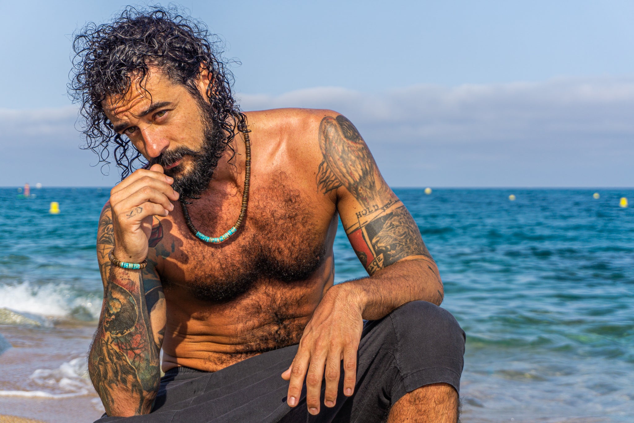 mens wearing a coconut shell and turquoise gemstone bracelet and a matching necklace- wander jewellery