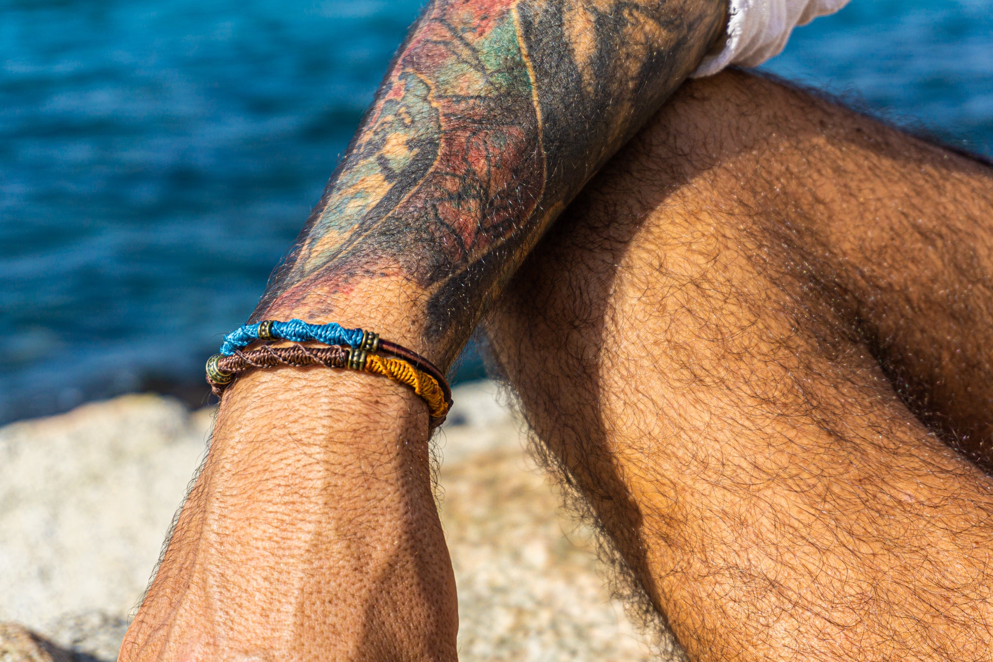 colorful mens bracelet set made f leather and decoreted with bronxe details and macrame patterns- wander jewellery
