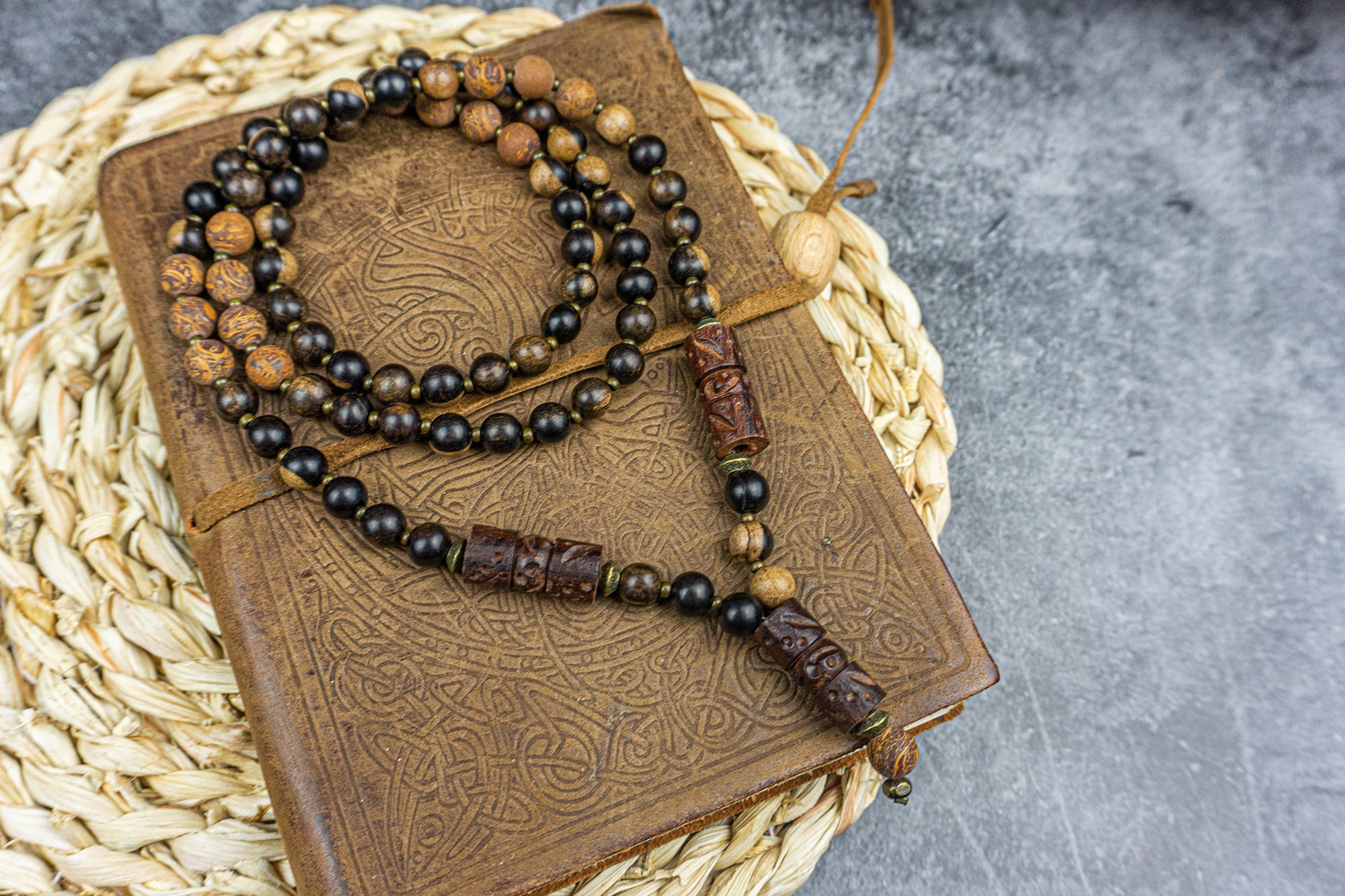 dark ebony wood and elephant skin beaded boho necklace with bronze details and three carved ebony wood pieces