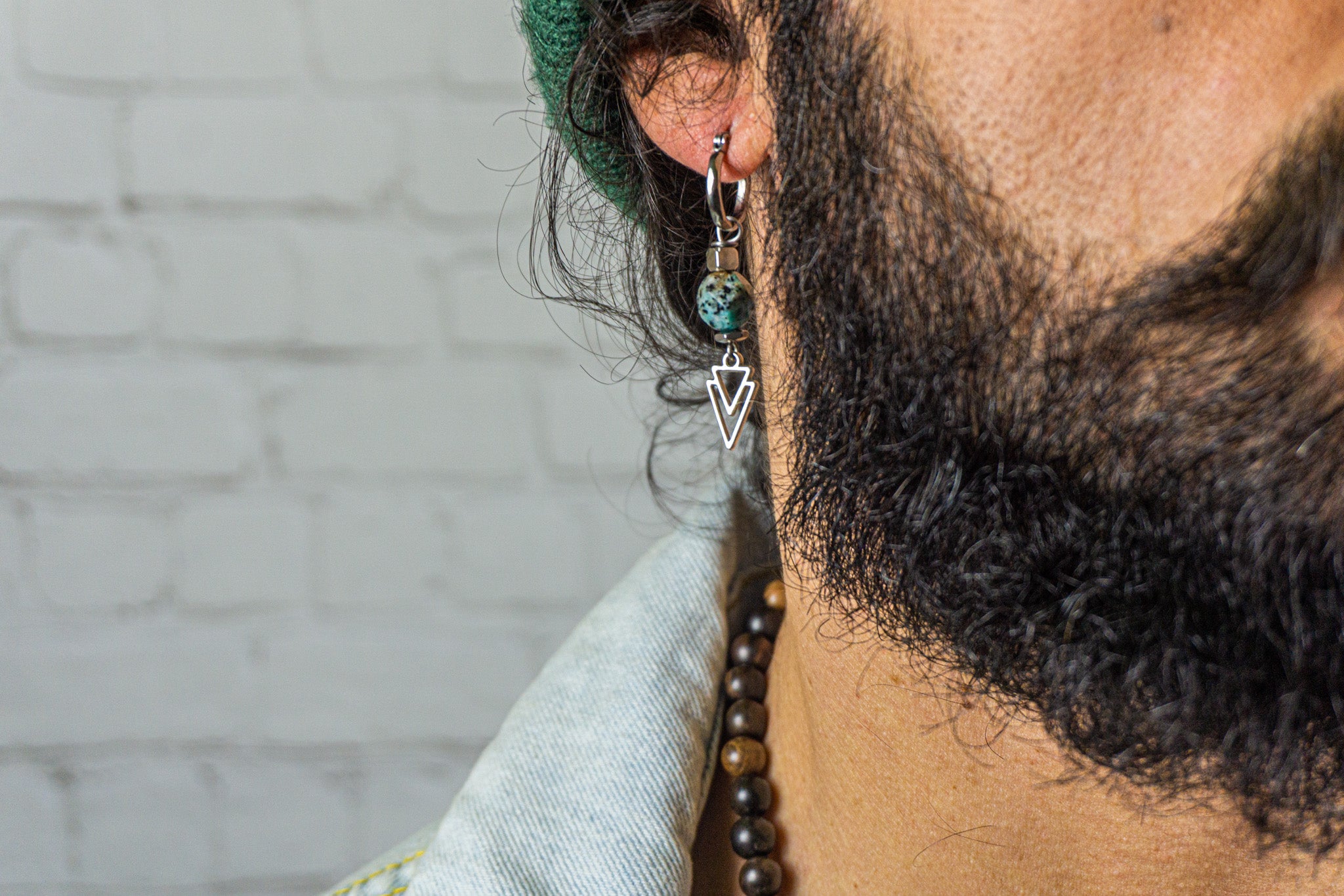 a single unisex earring with a kiwi jasper gemstone, stainless steel beads and a triangle charm.