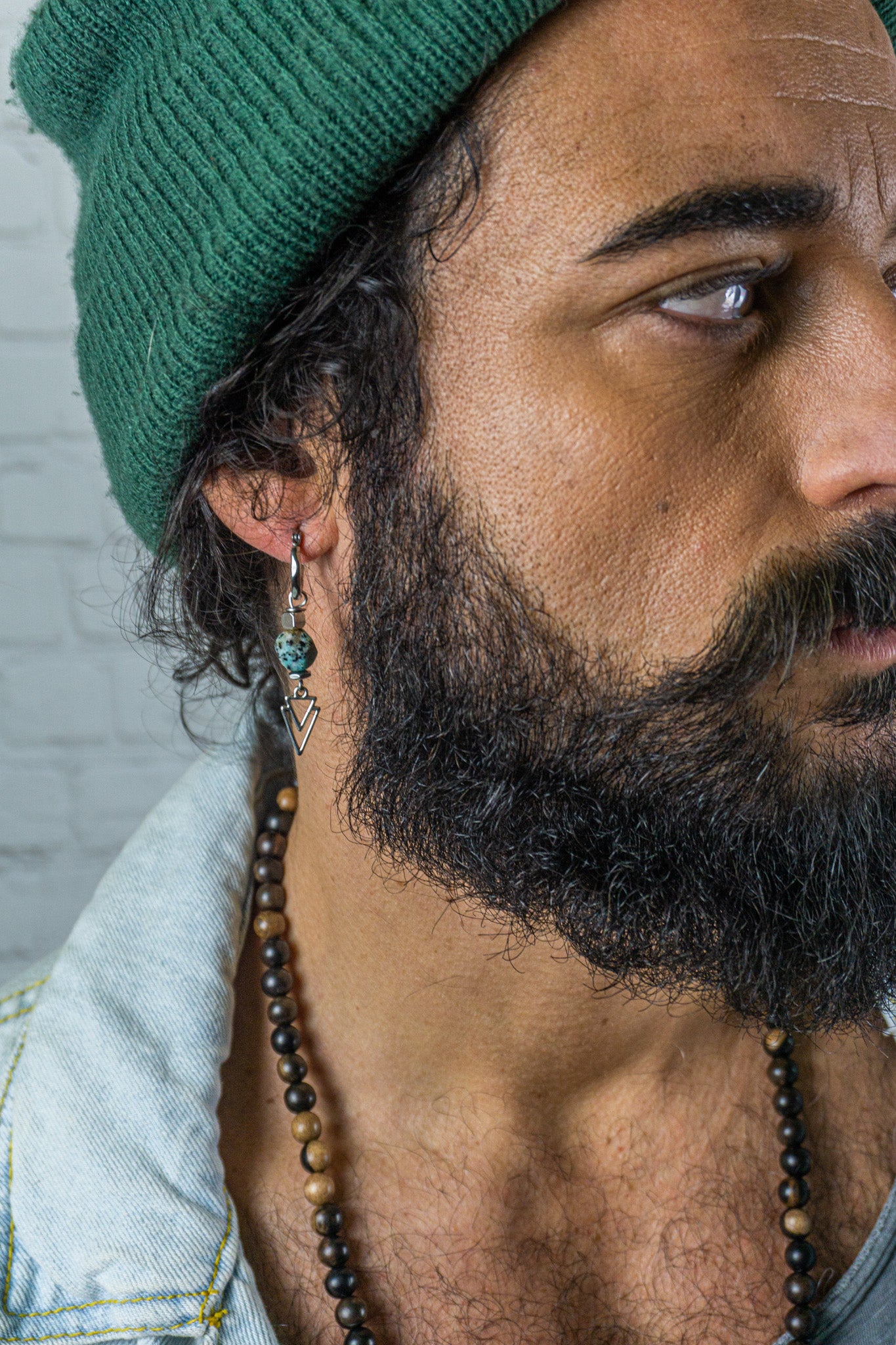 A modern single earring on a stylish man