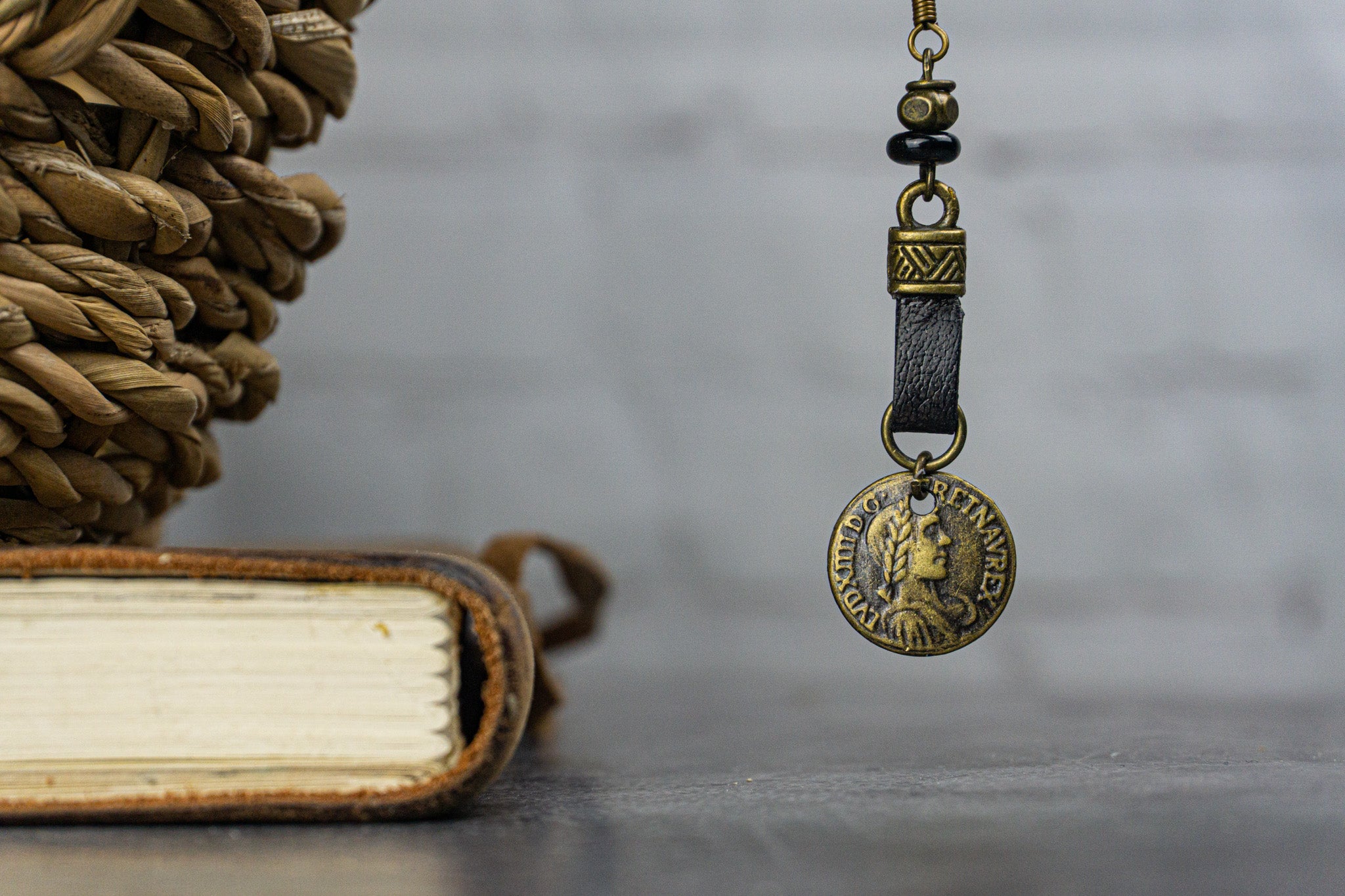 french hook earring, leather loop with an ancient bronze coin