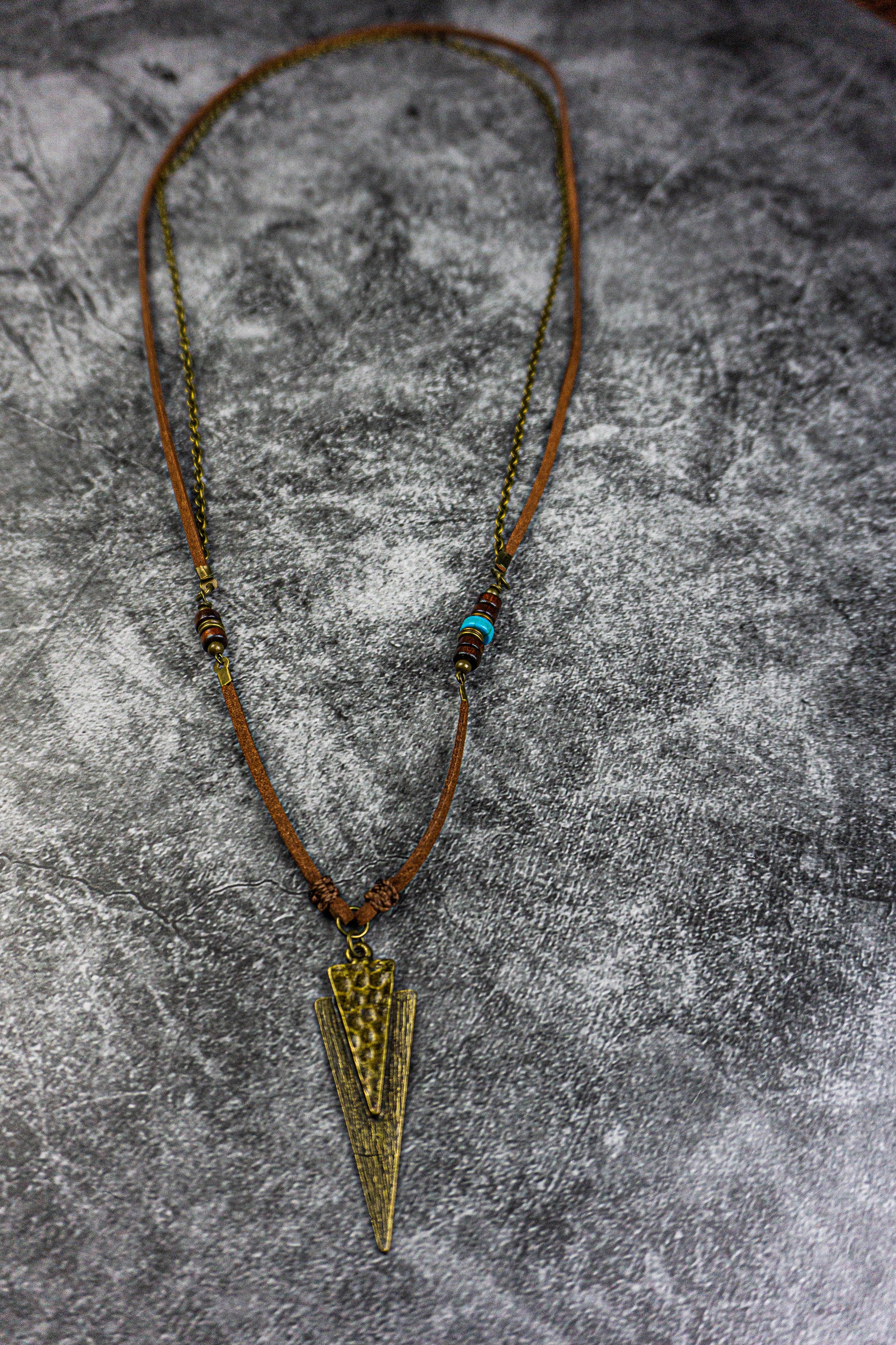 long leather and chain necklace with a hammered triangle antique bronze pendant