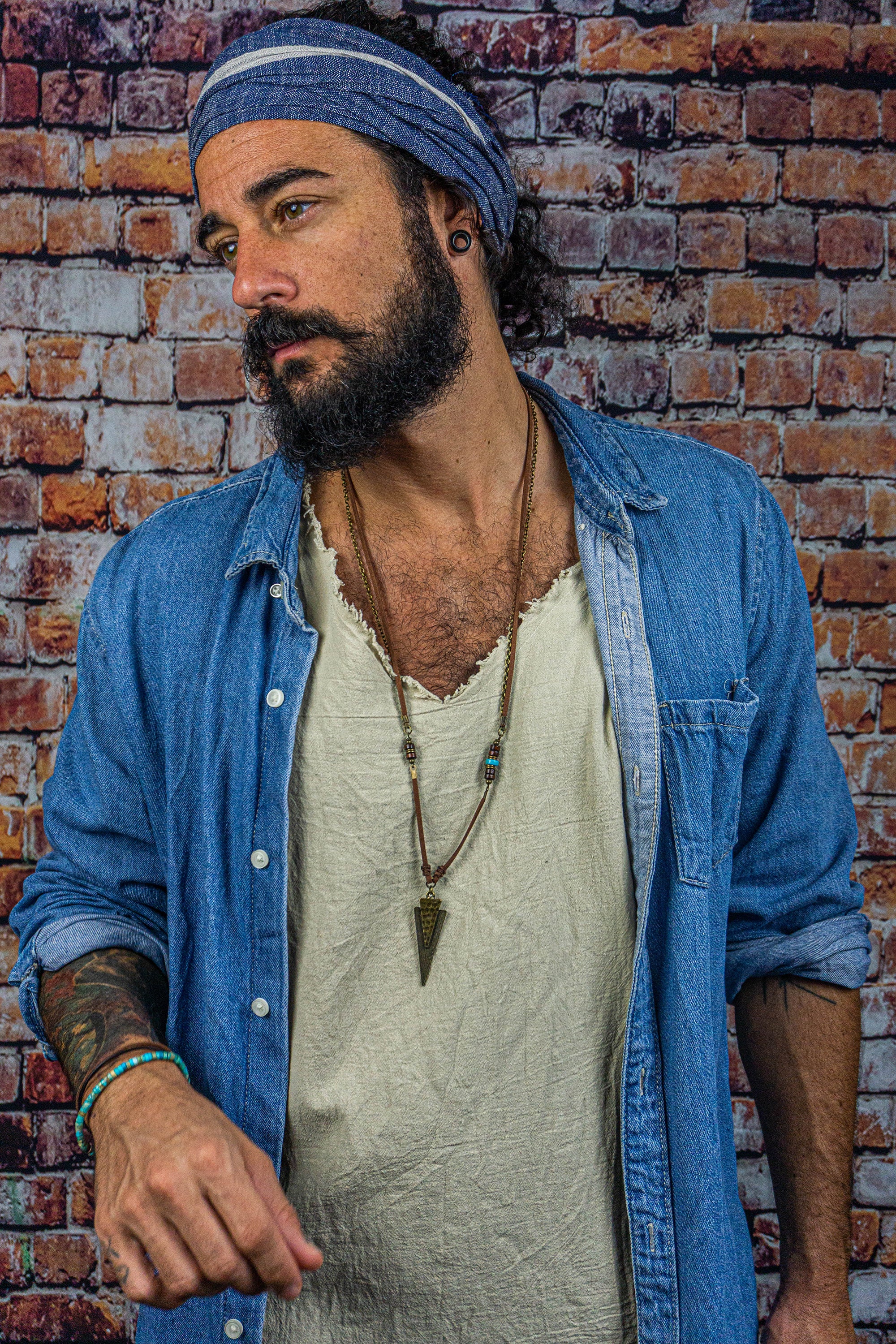 long leather and chain necklace with a triangle arrowead antique bronze pendant