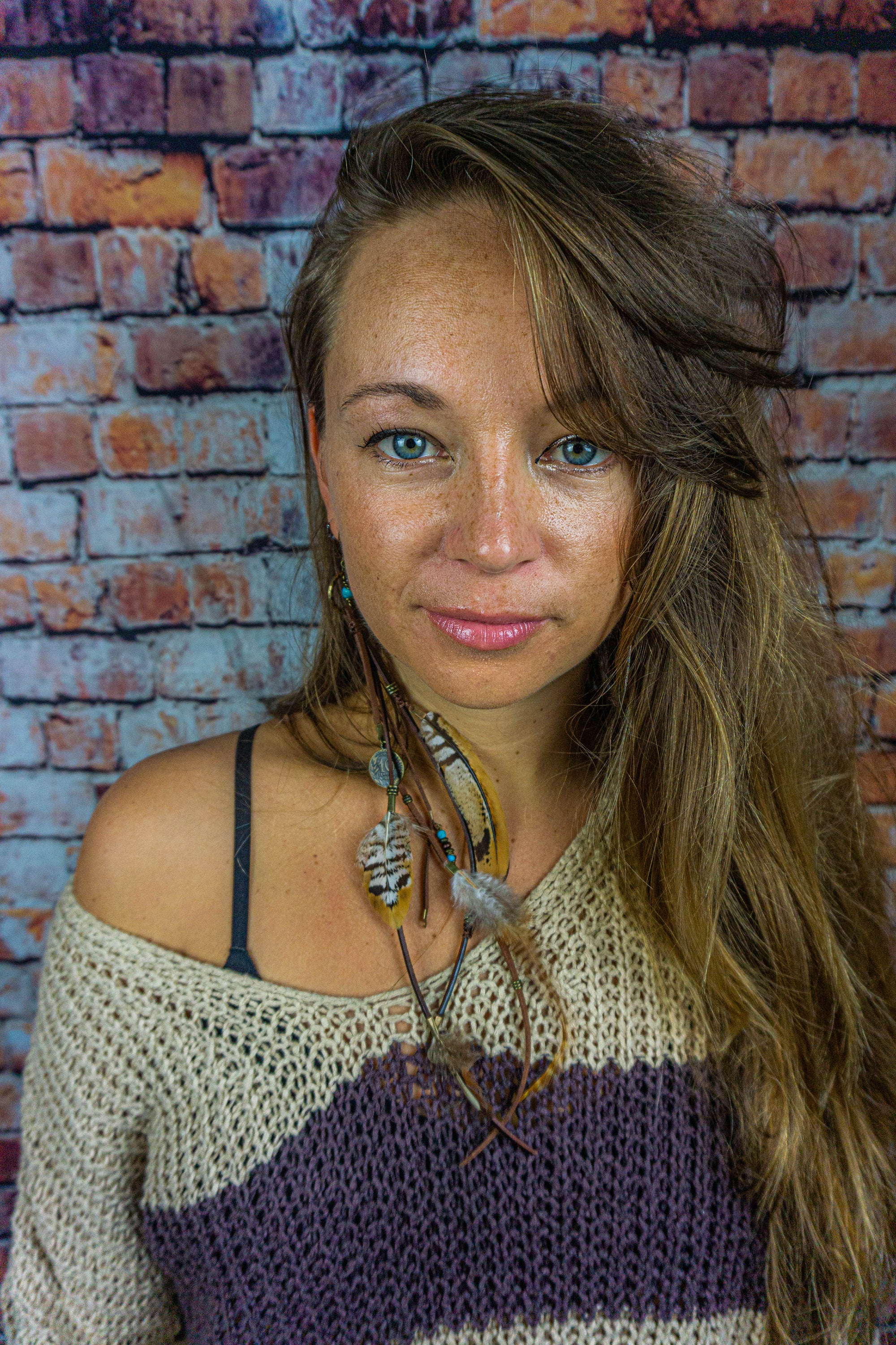 girls long earring made of leather and feathers- wander jewellery