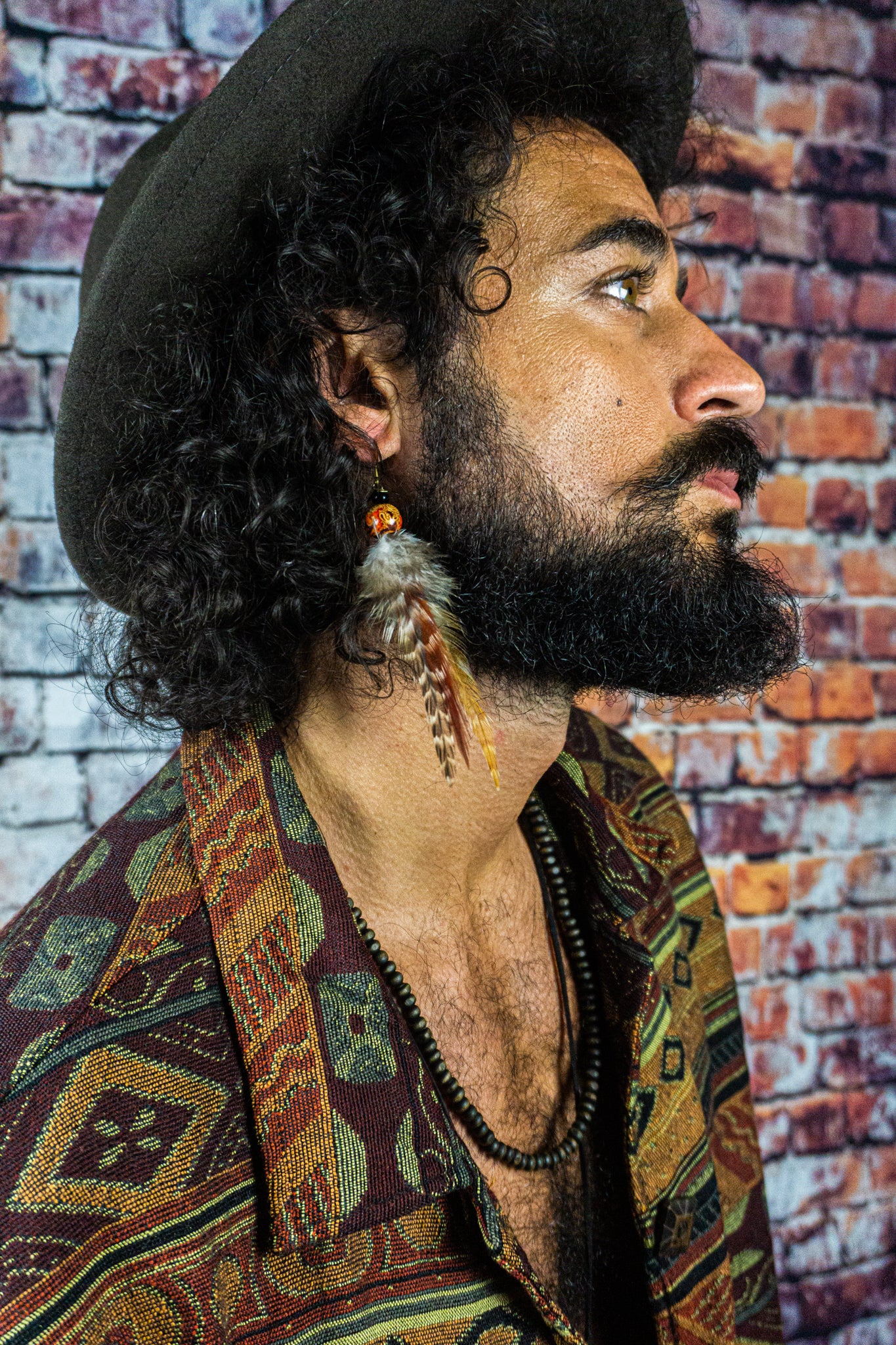 mens-wearing-a-beaded-long-colorful-feather-earring