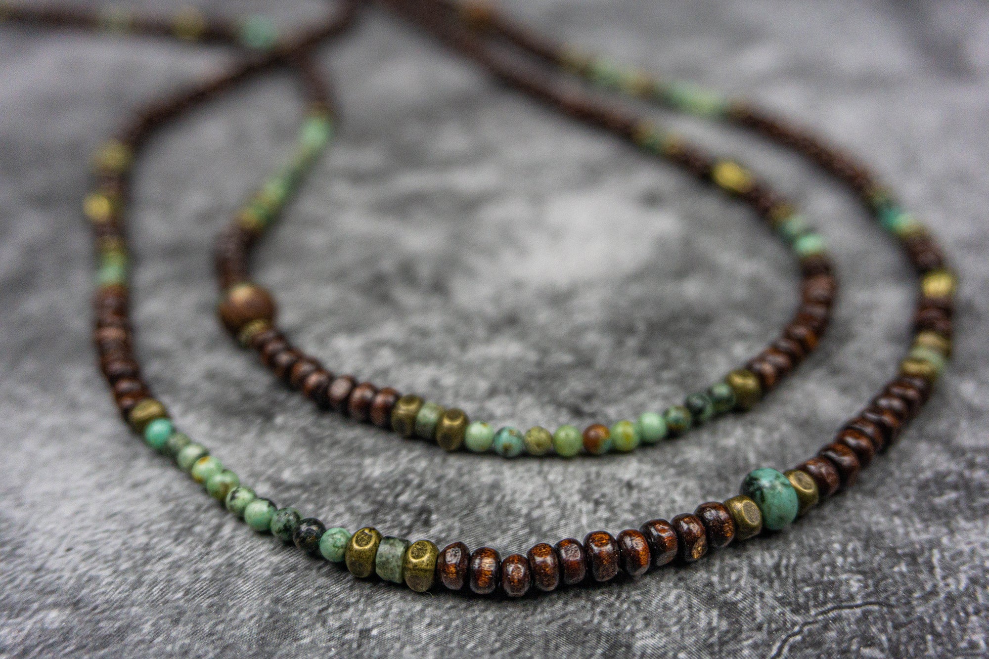 necklace made of wood and green gemstone bads and bronze deatils- wander jewellery