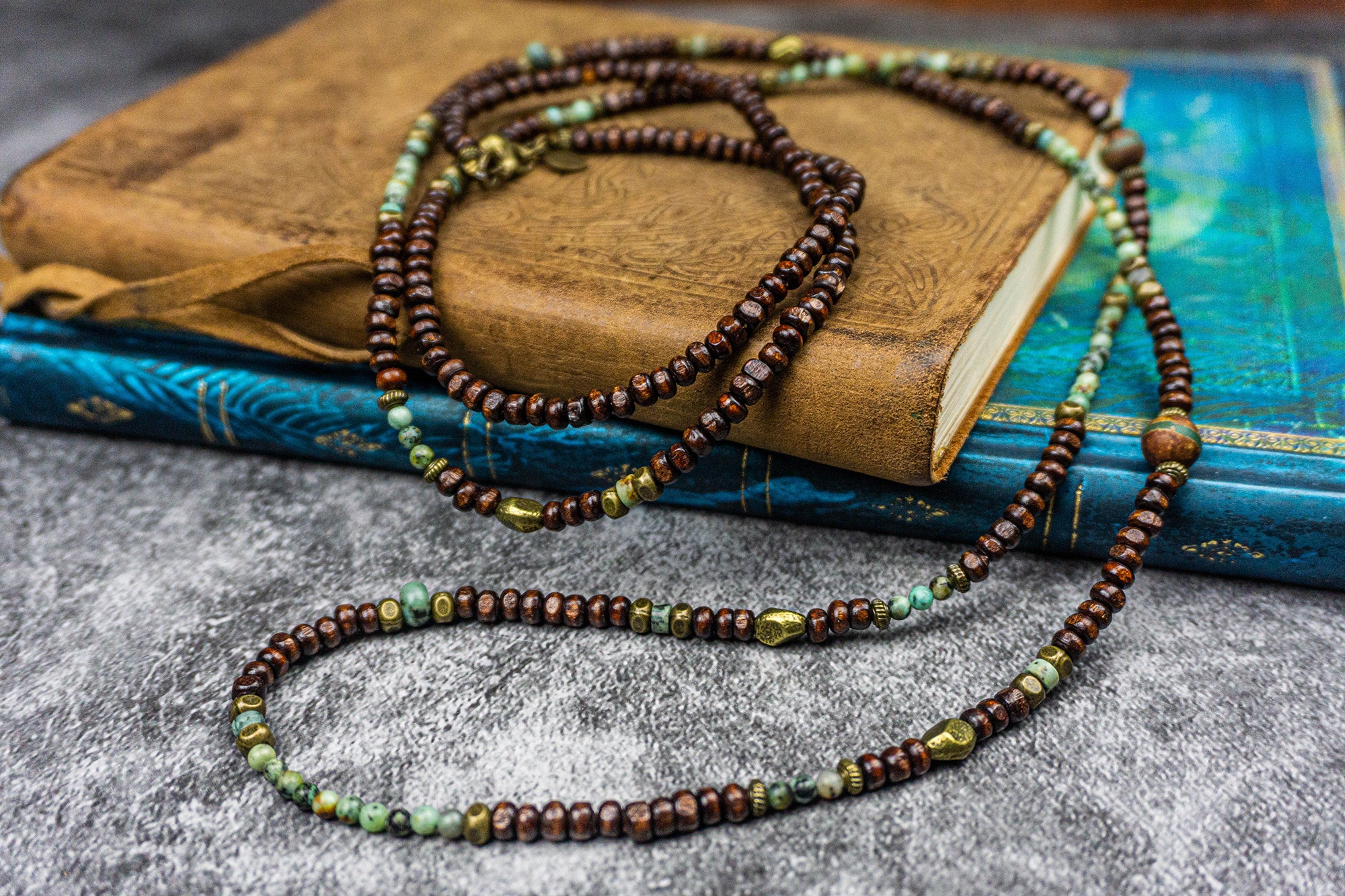 long necklace made of wood and green gemstone bads and bronze deatils- wander jewellery