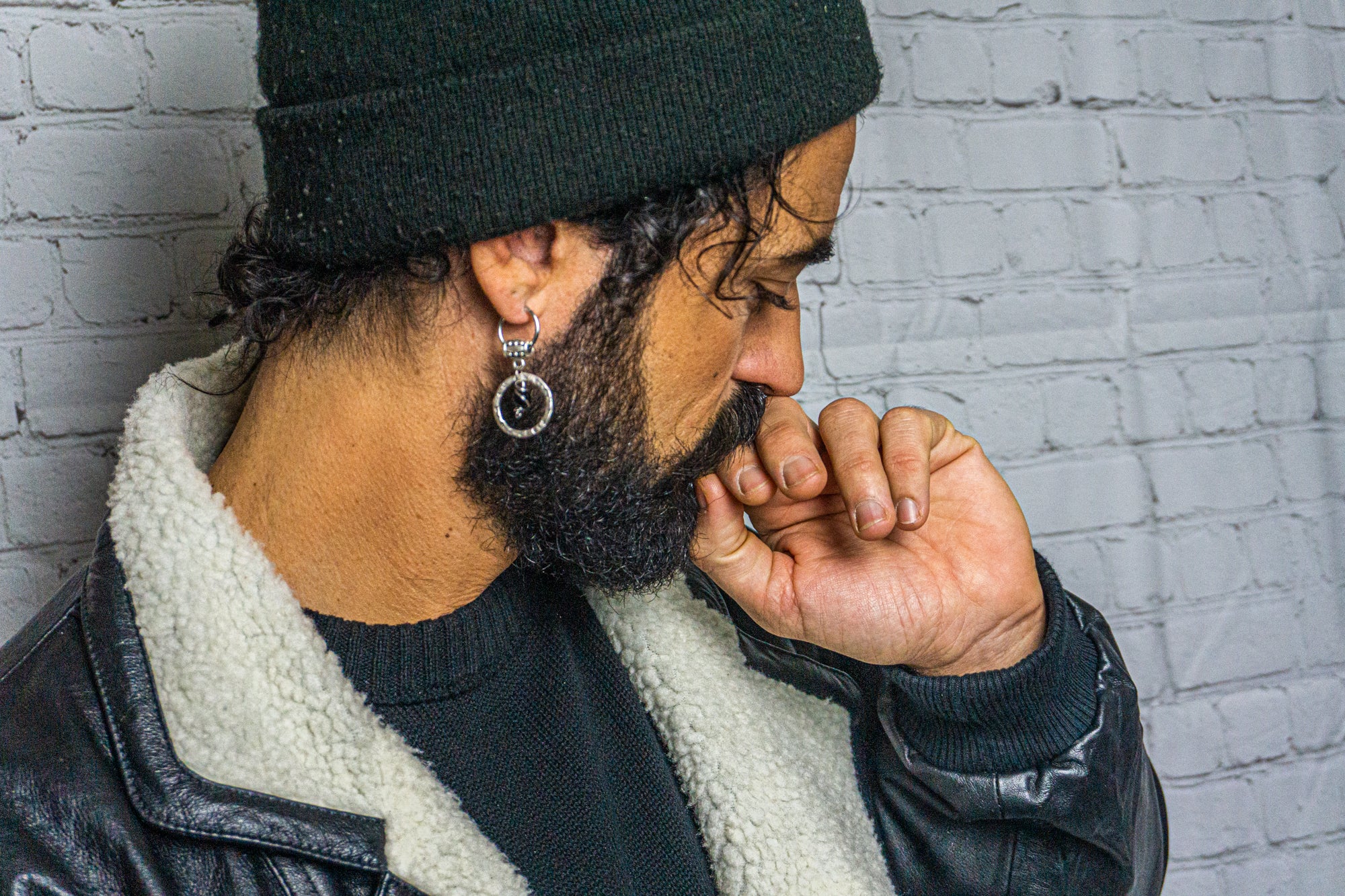 mens wearing a silver hoop dangle earring with a central black onyx bead
