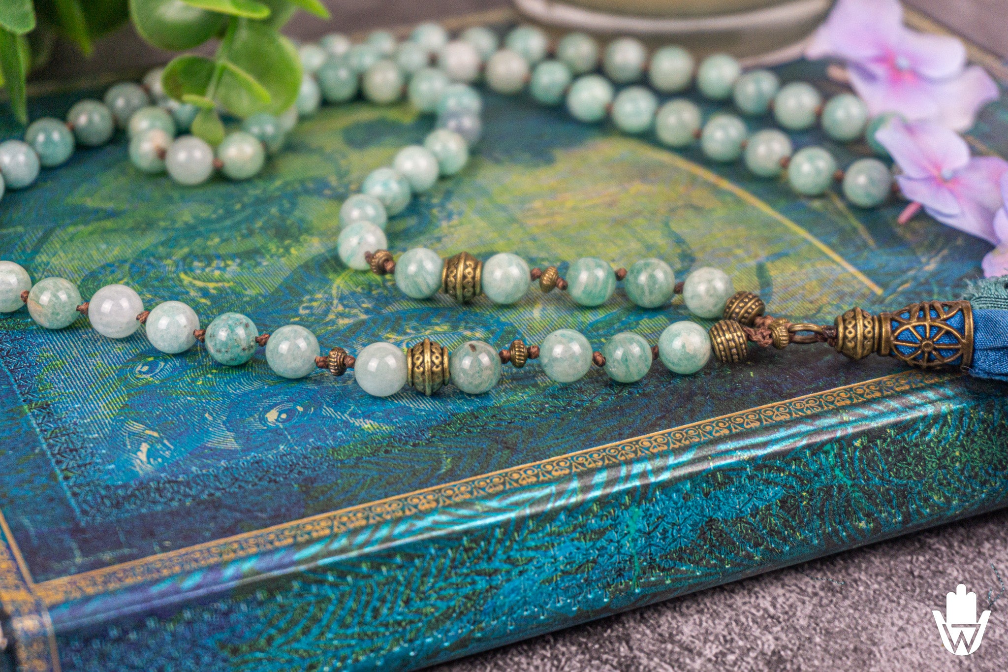 close up of a turquoise necklace on a blue book