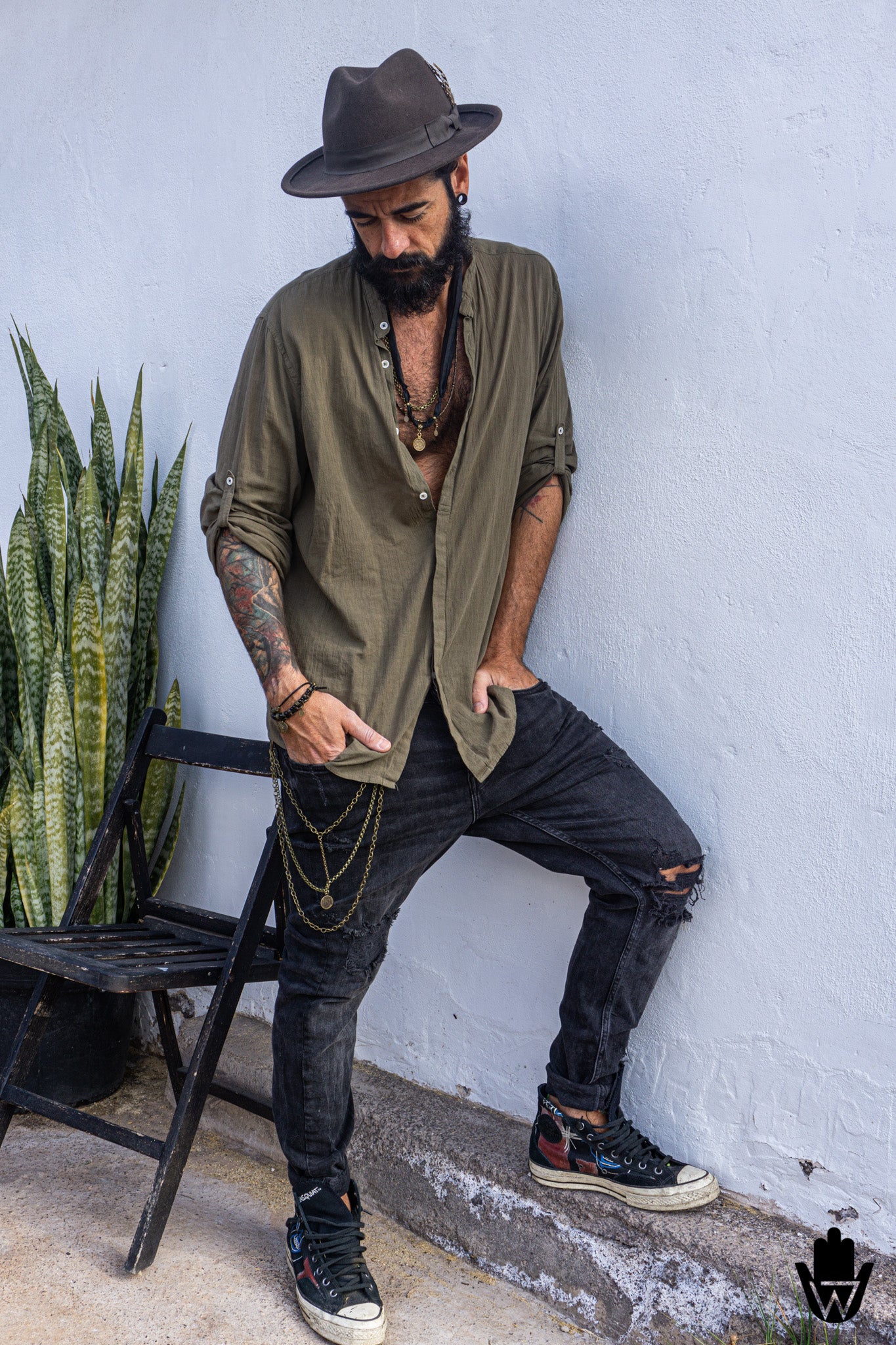 man wearing boho clothes with boho jewelry and a bronze layered chain for pants