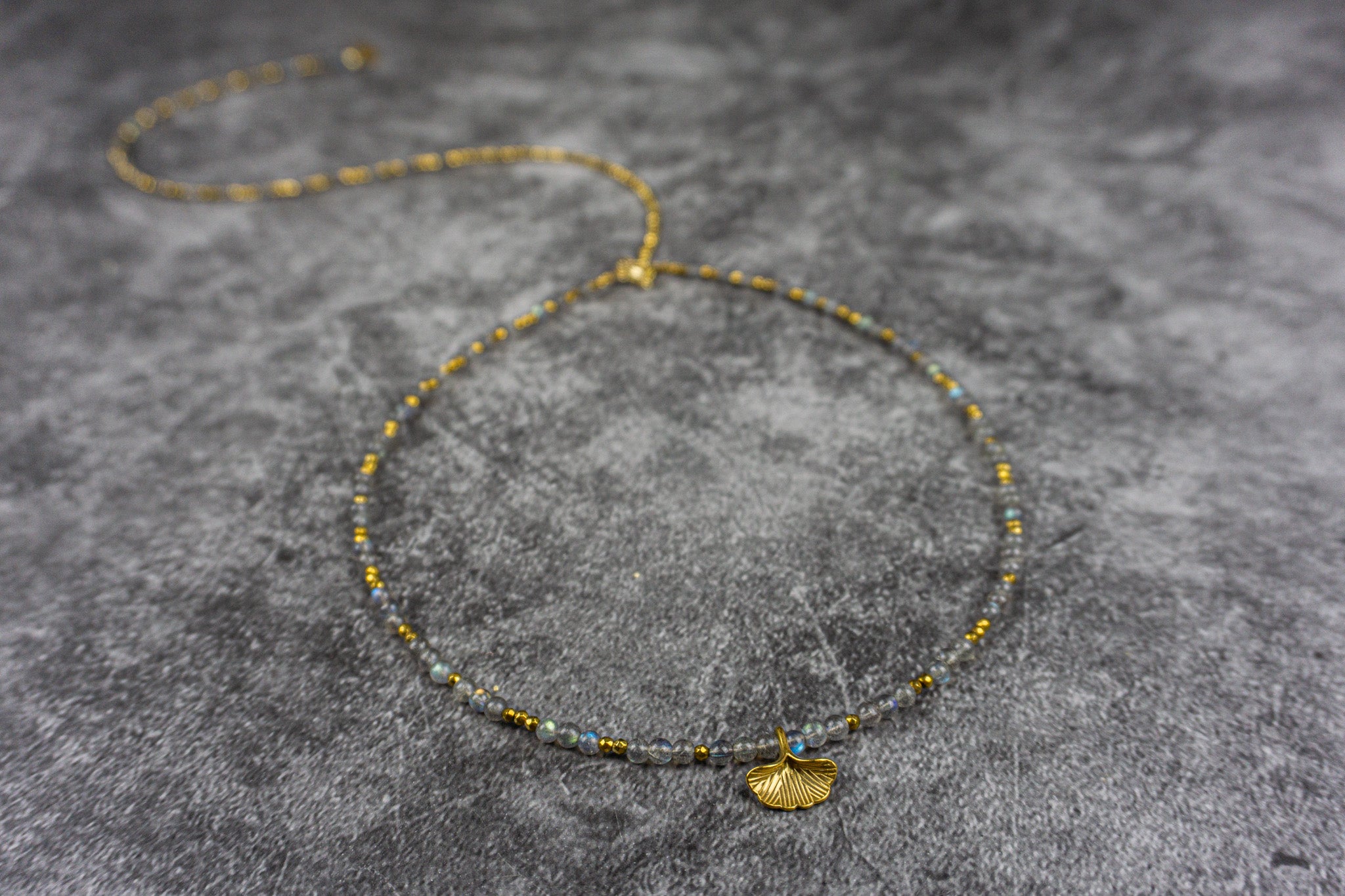 Boho chic necklace with labradorite and hematite beads, featuring a golden Ginkgo leaf charm – Wander Jewellery