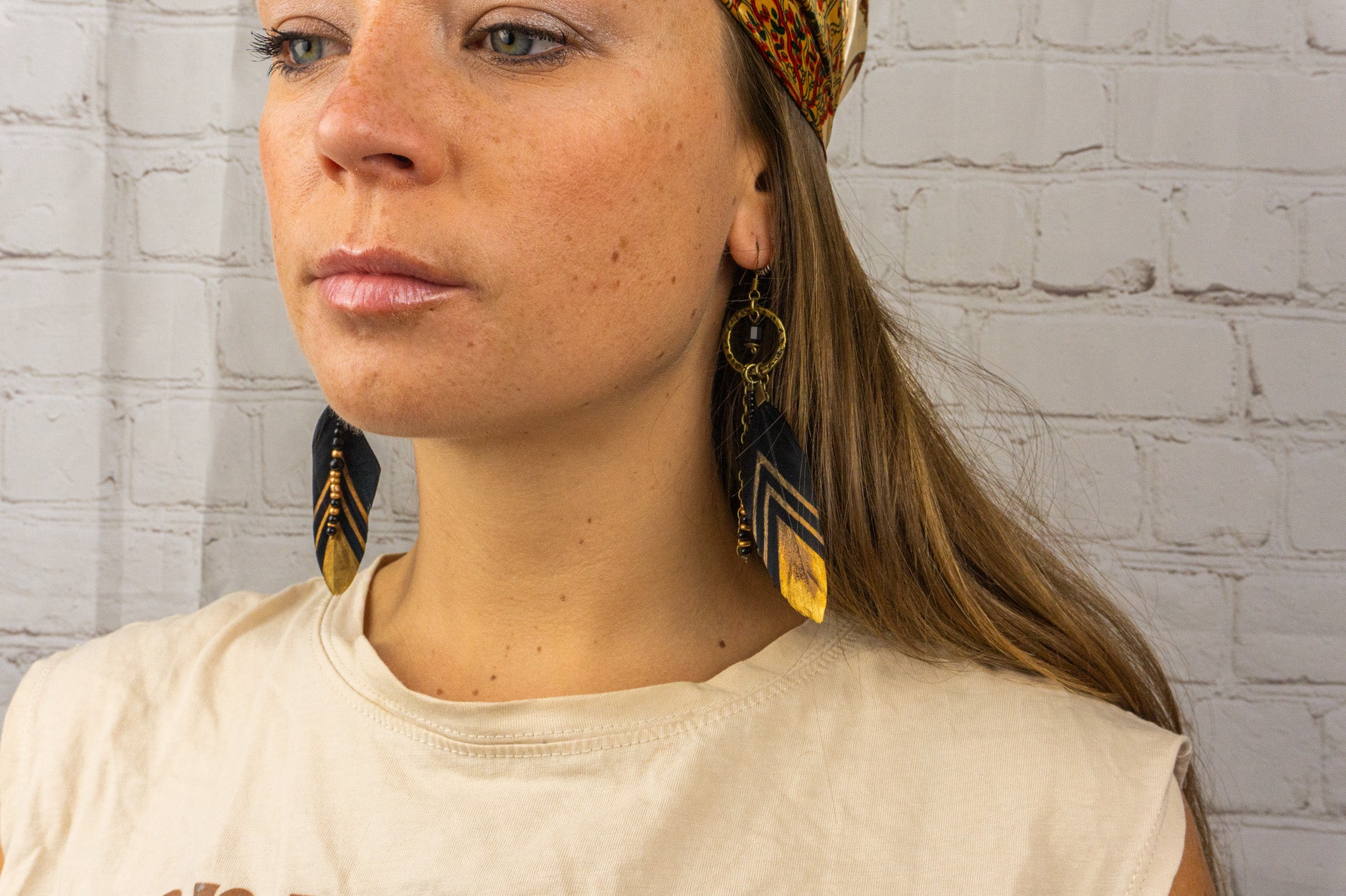womens black and gold boho feather earring with beads and gemstones- wander jewellery