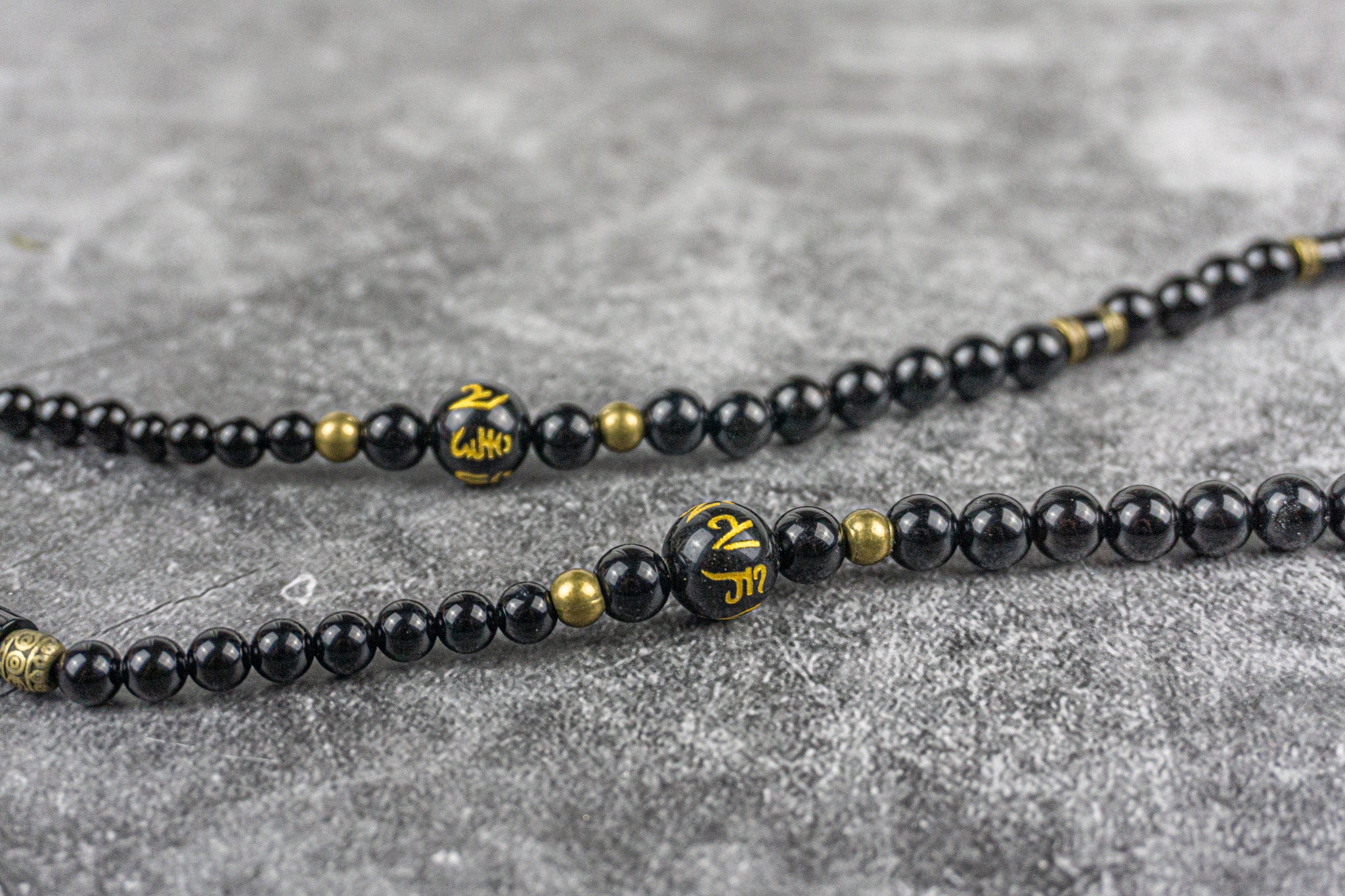 black onyx and antique gold long elegant necklace with tibetan ideogram - wander jewellery