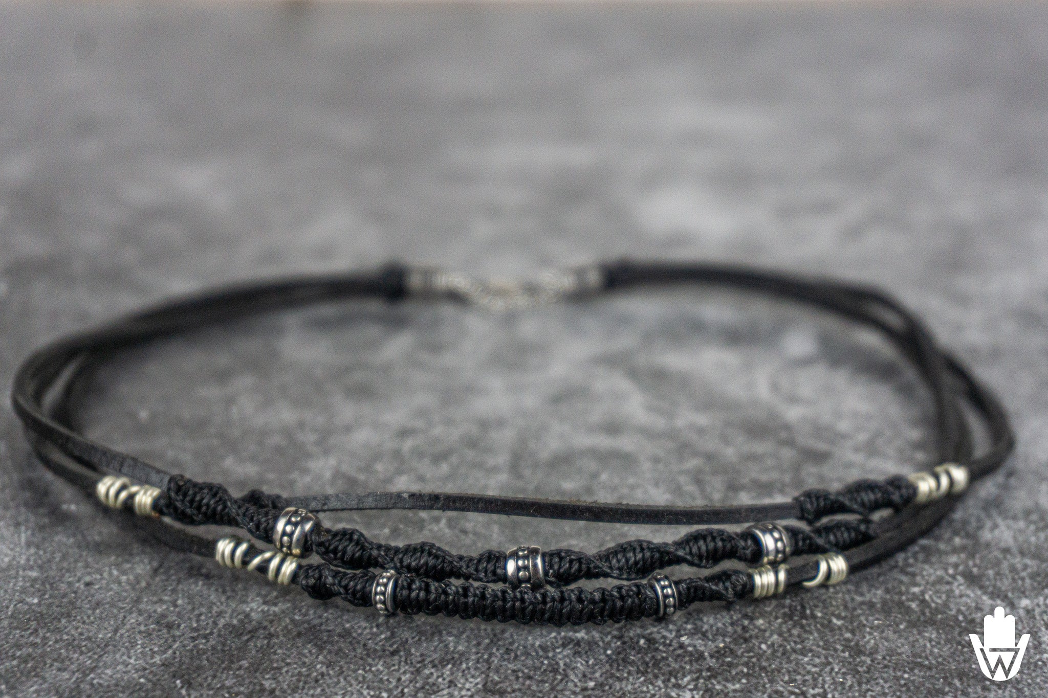 close up of a 3 layer black and silver necklace
