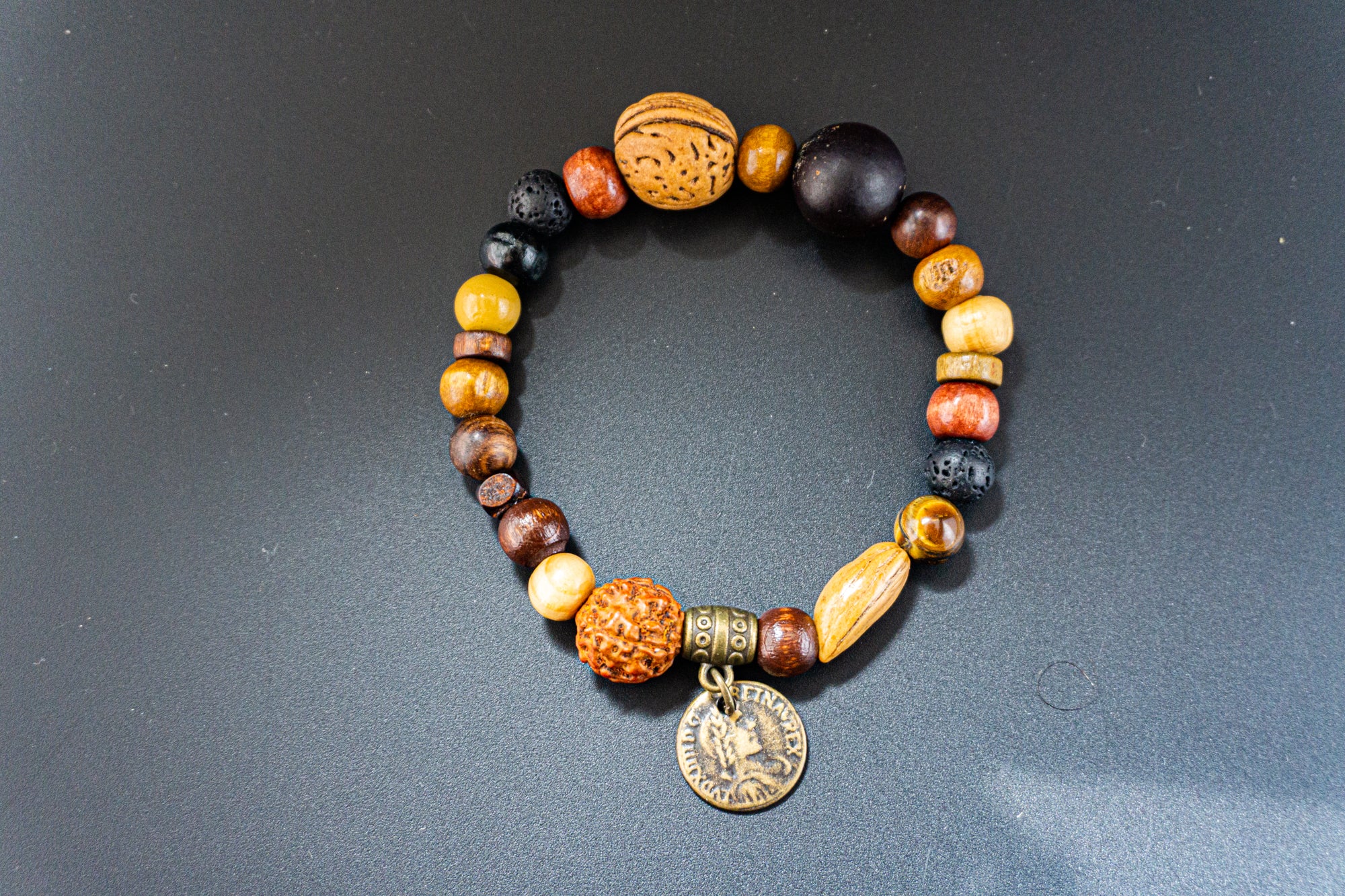 wood and seed beaded bracelet with ancient bronze coin charm- wander jewellery