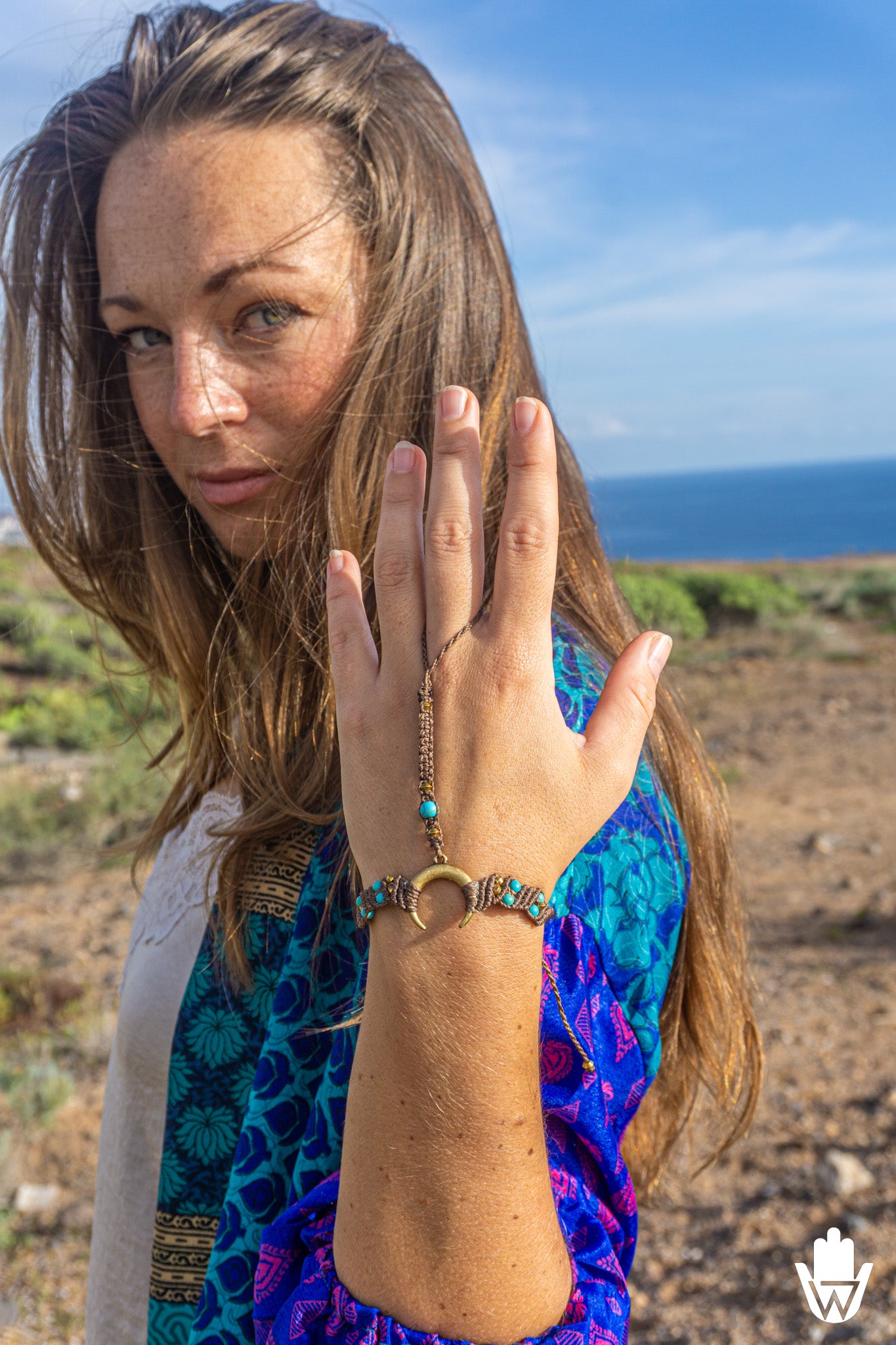 Woman in a colorful dress with a hand bracelet