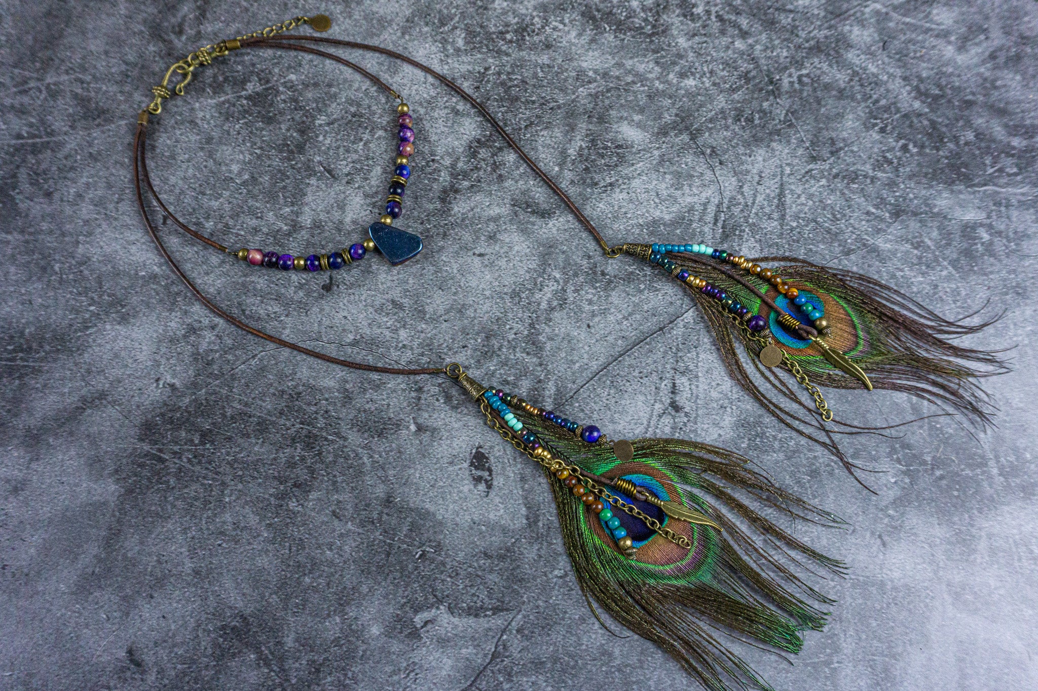 bohemian wrap choker necklace made of galaxy tiger eye gemstone and two dangle charm peacock feathers- wander jewellery