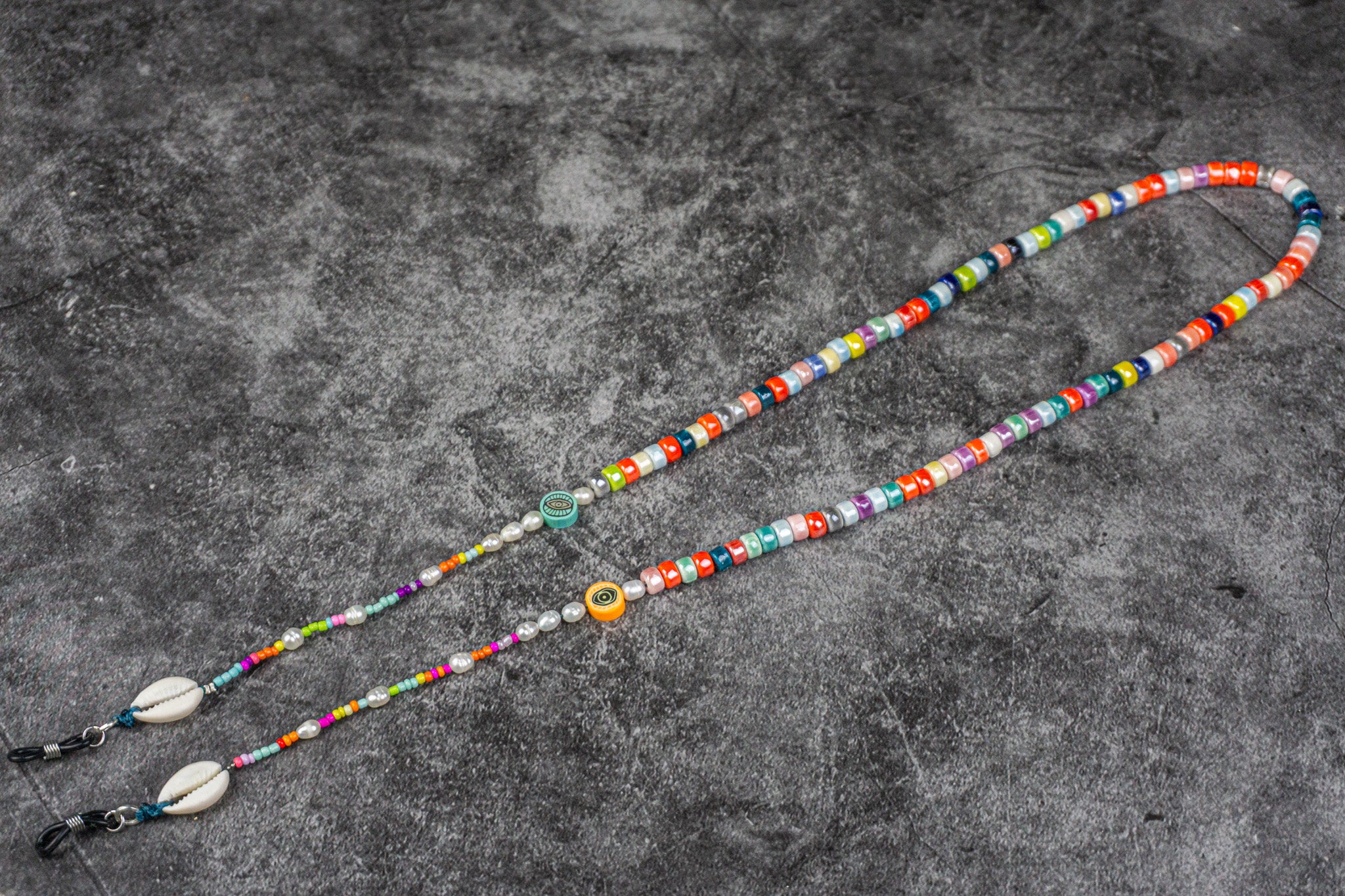 Vibrant beaded glasses chain holder with porcelain beads, pearls, and cowrie shells, wrapped in eco-friendly packaging – Wander Jewellery