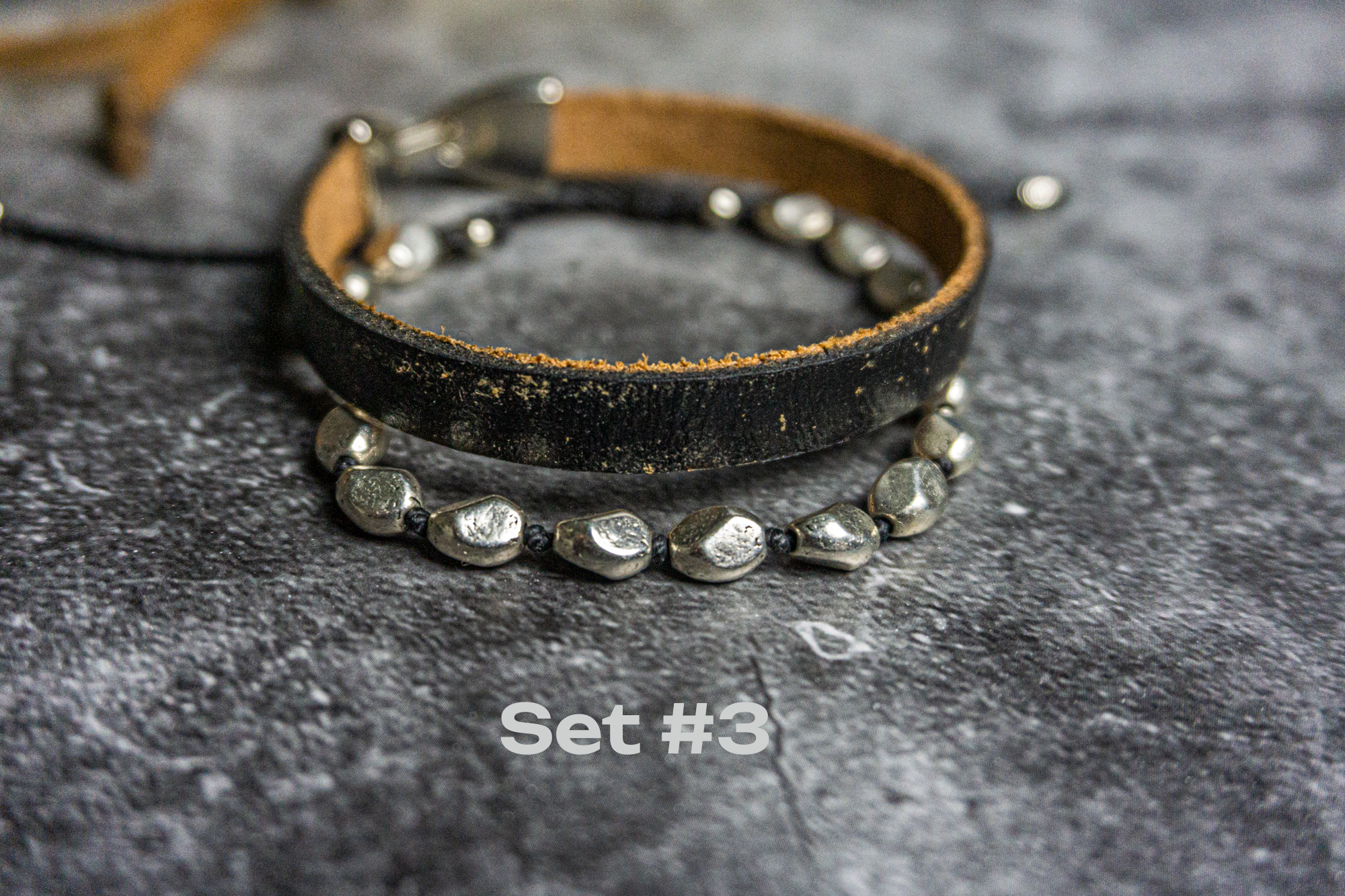 bracelet set made of one black leather vintage bracelet and one silver colored adjustable bracelet- wander jewellery