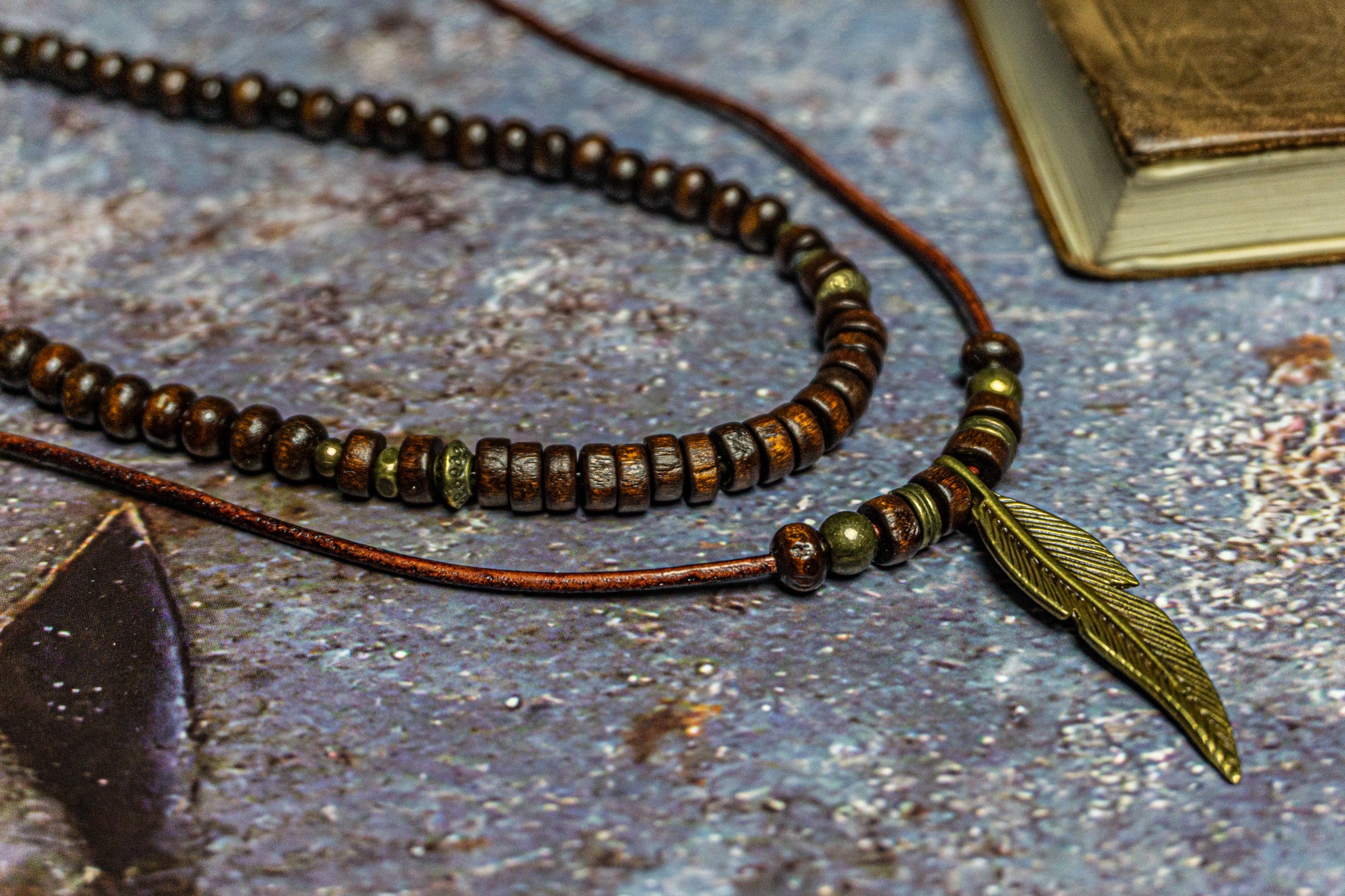 necklace set made of a wooden bead necklace and a leather necklace with a bronze feather as a pendant- wander jewellery