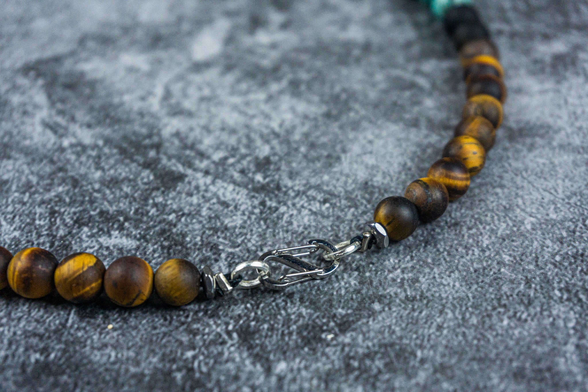 details of the stainless steel closure on a tiger eye beaded necklace- wander jewellery